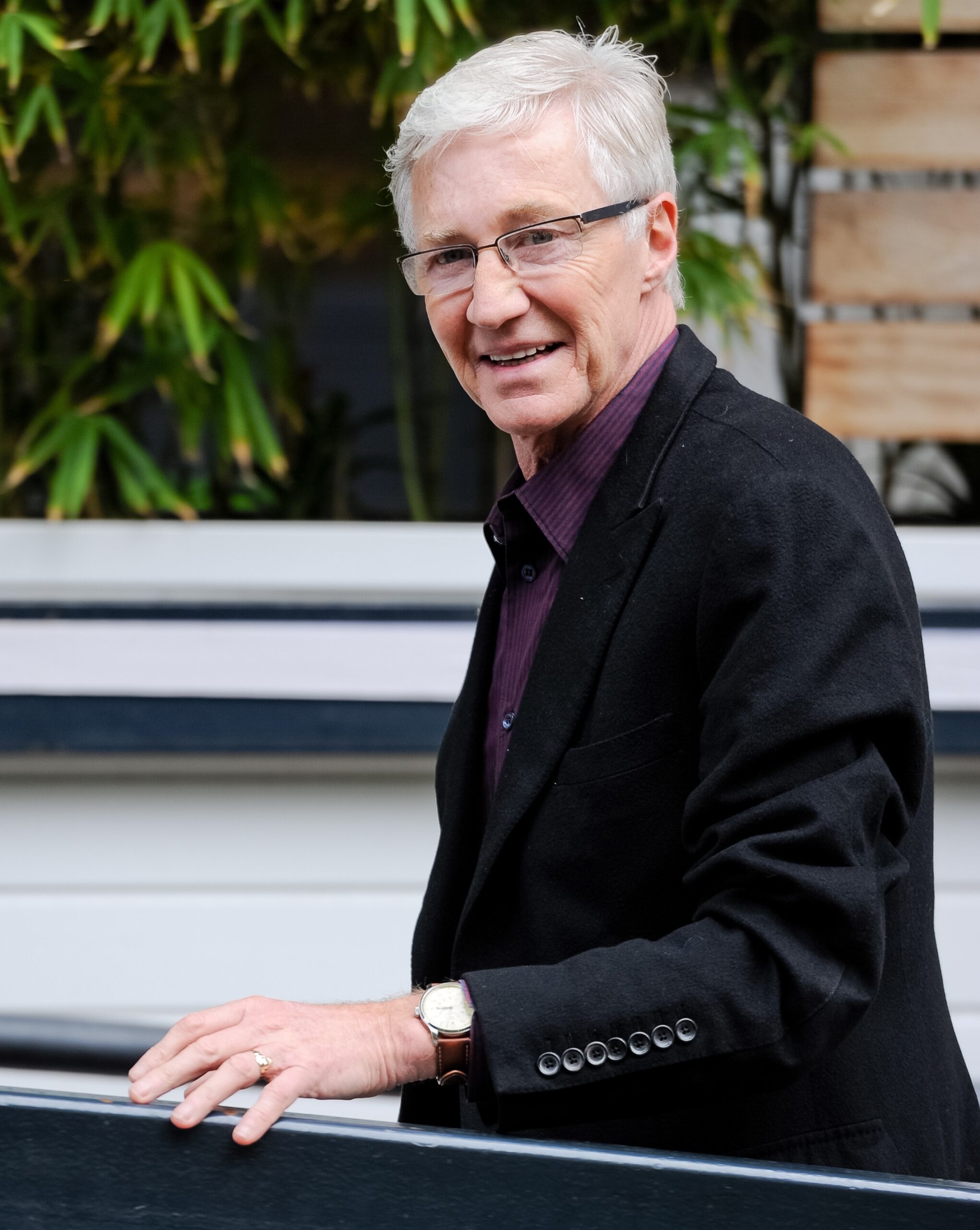 Paul O'Grady smiling wearing a black jacket