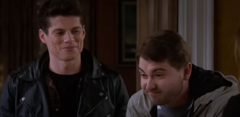 Nicky and his mystery visitor smile on Emmerdale