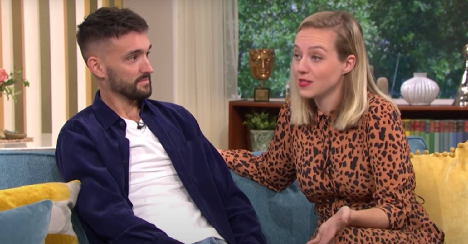 Tom Parker sits with Kelsey Parker as she makes her point