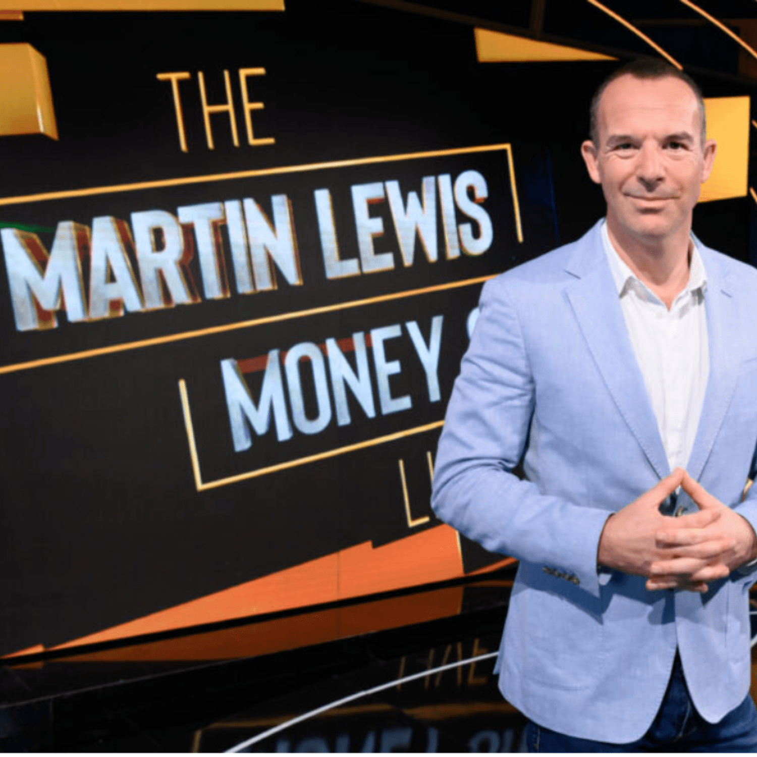 Martin Lewis stands infront of screen