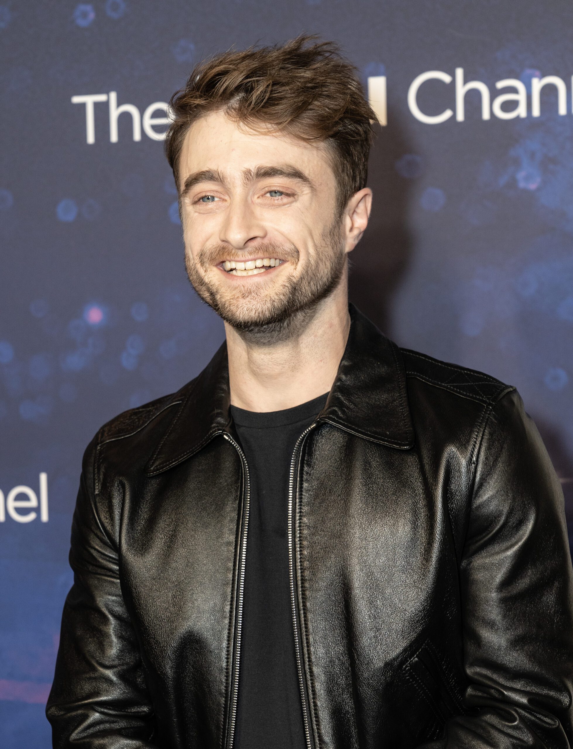 Daniel Radcliffe beaming on the red carpet