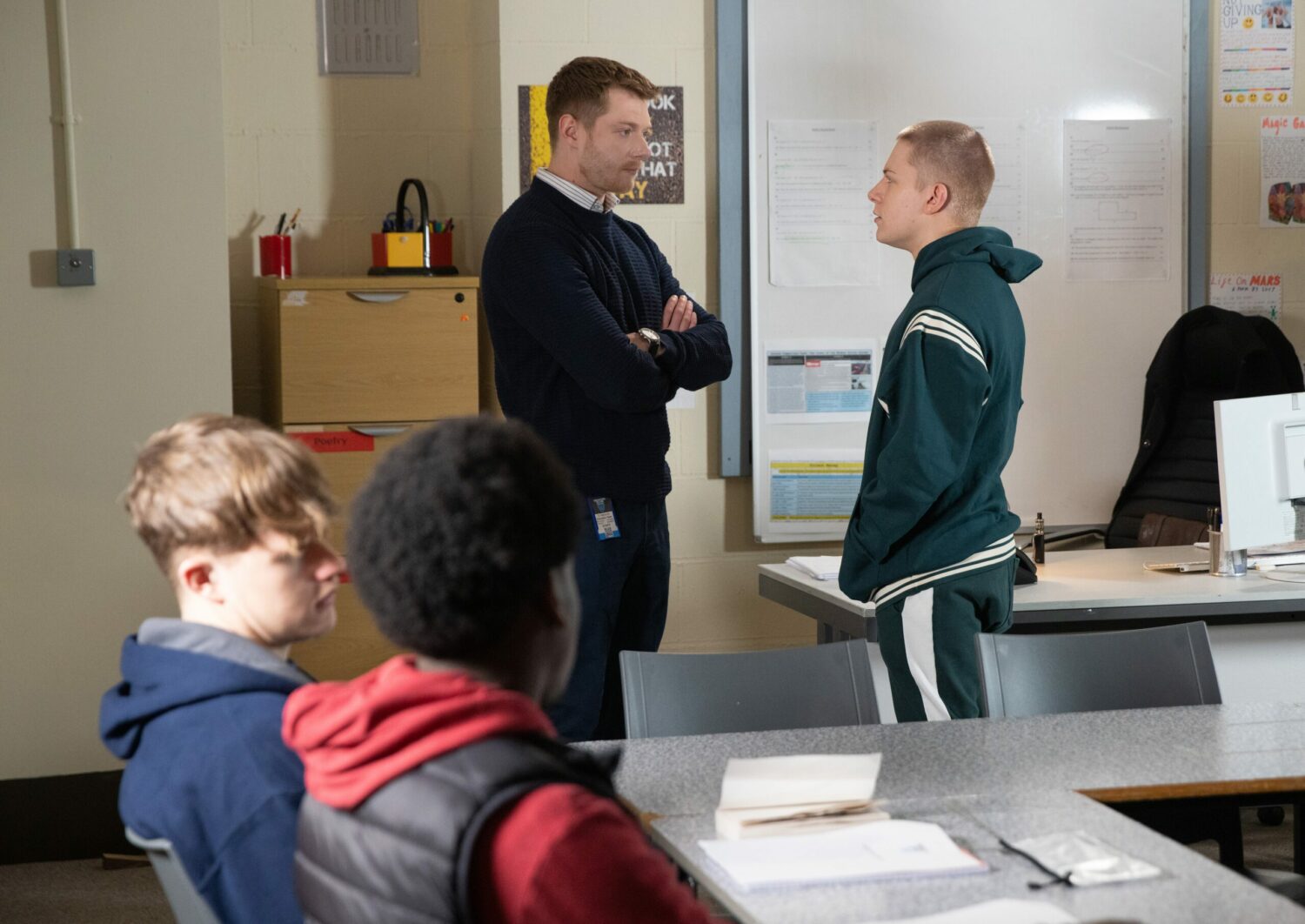 Daniel Osbourne folds his arms as he talks seriously to disruptive Max Turner