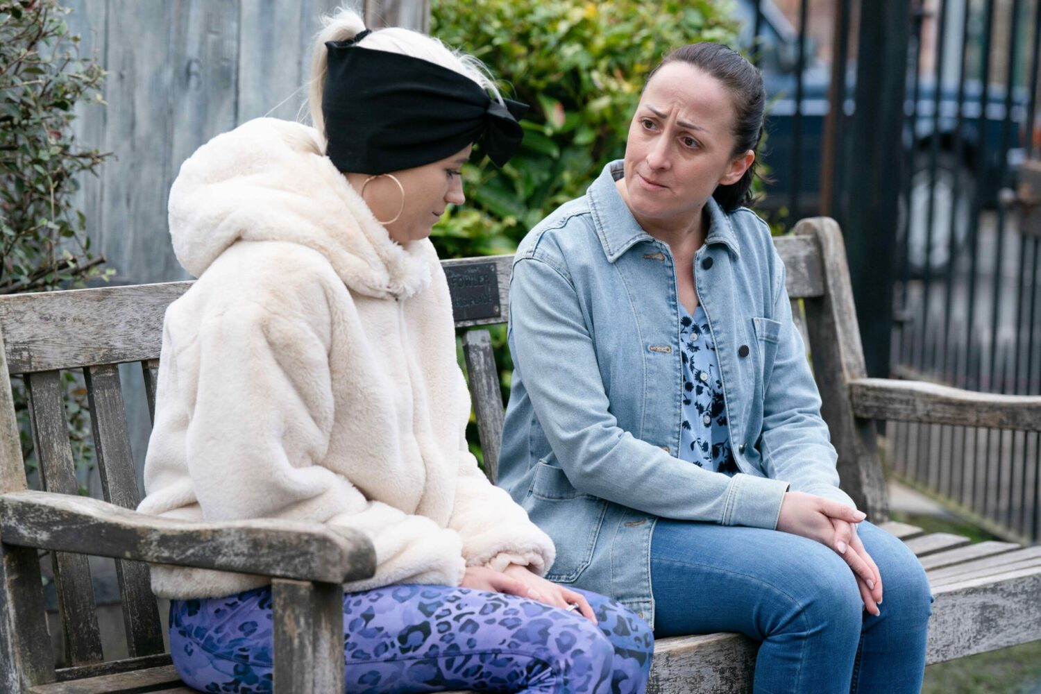 Lola Pearce and Sonia Fowler on a bench in the Square with Sonia looking anxious