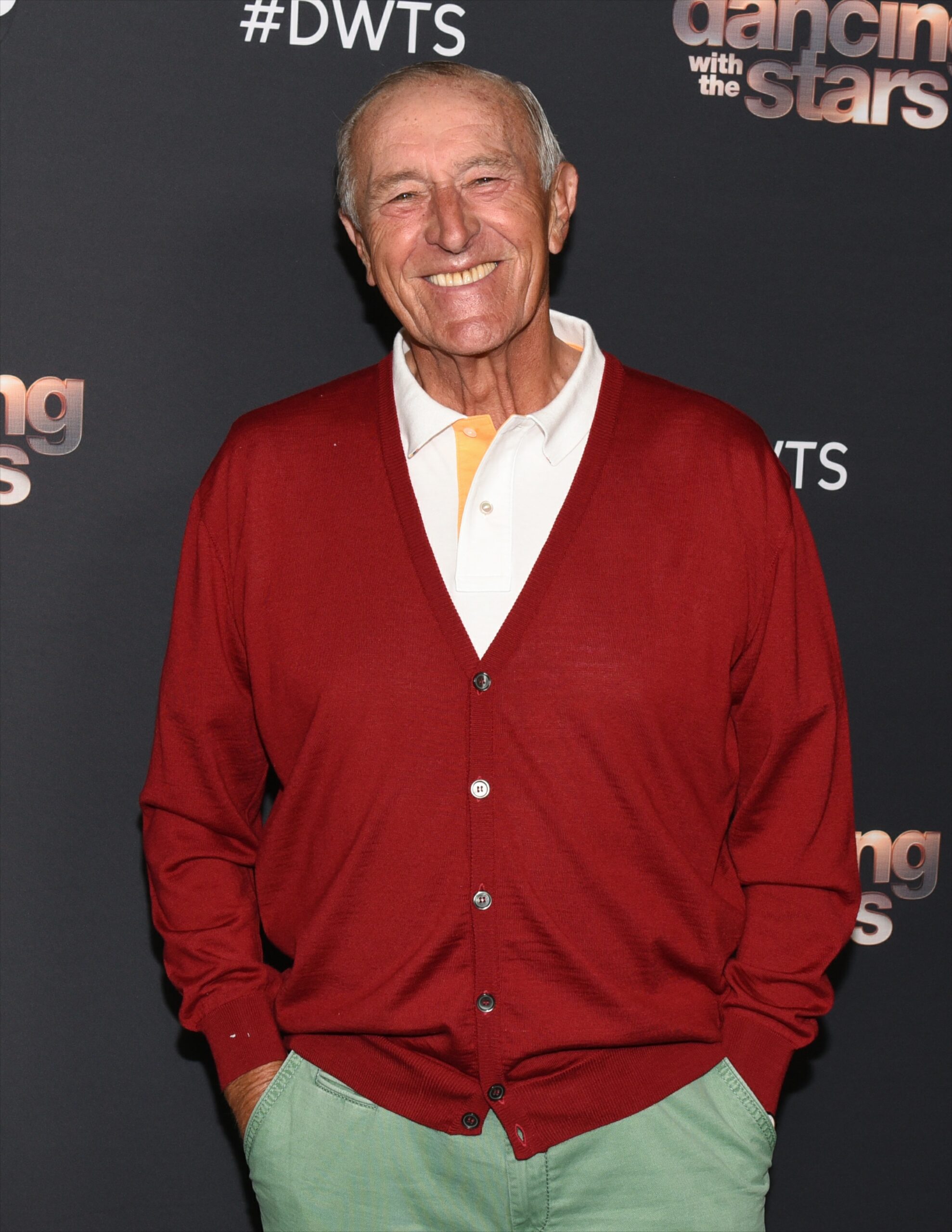 Len Goodman smiling in a red cardigan