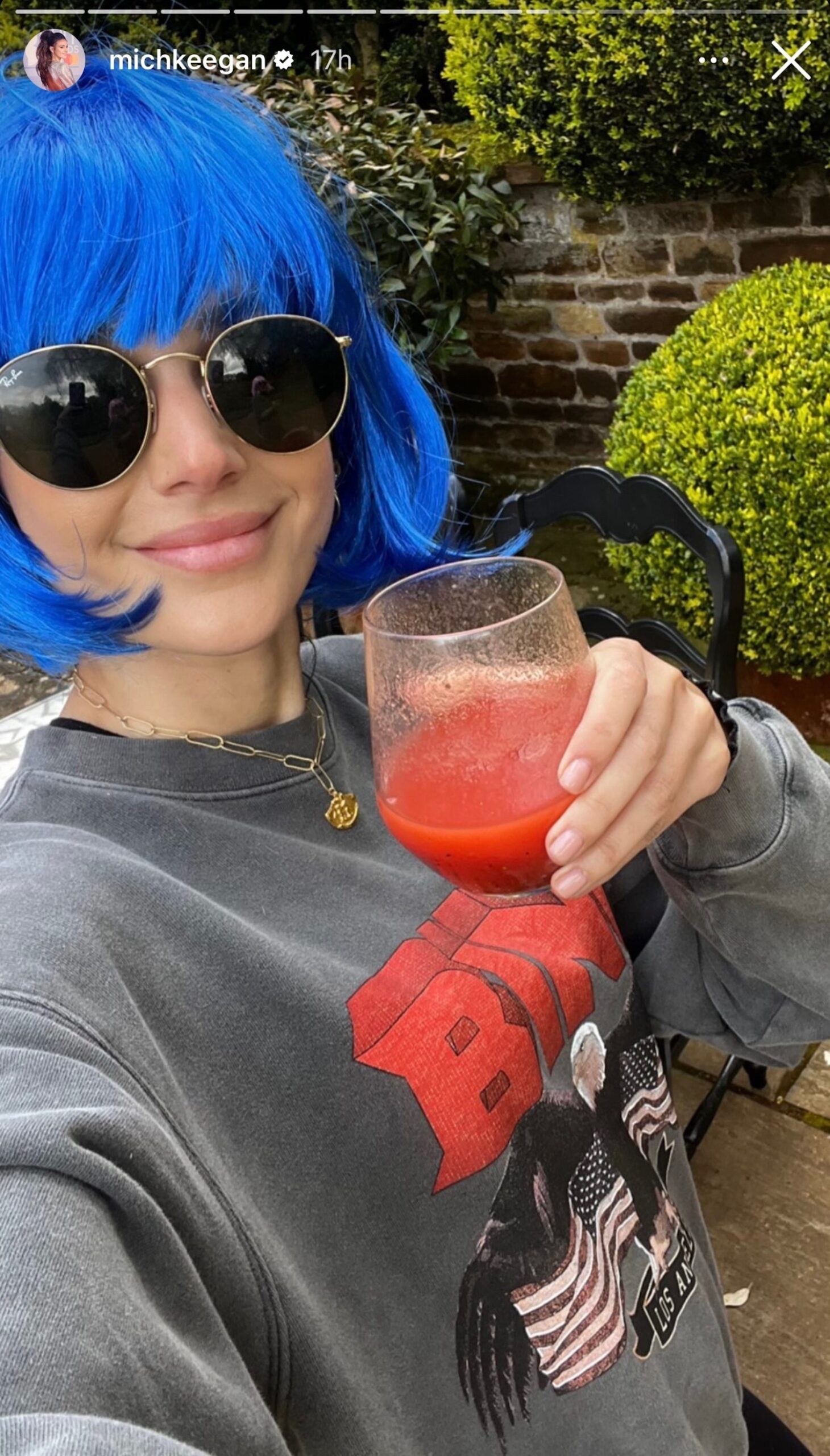 Michelle Keegan posing in a blue wig for her Instagram Story