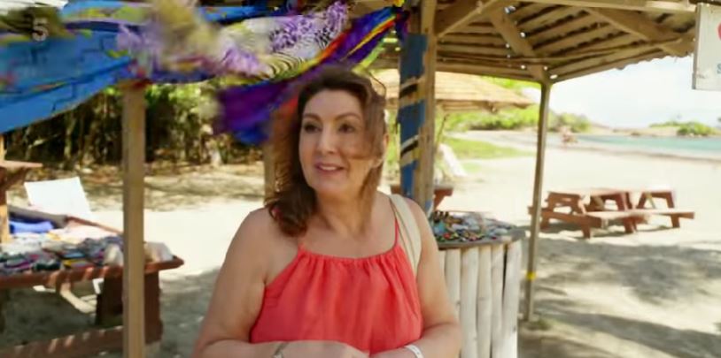 Jane McDonald smiling on a beach in St. Lucia