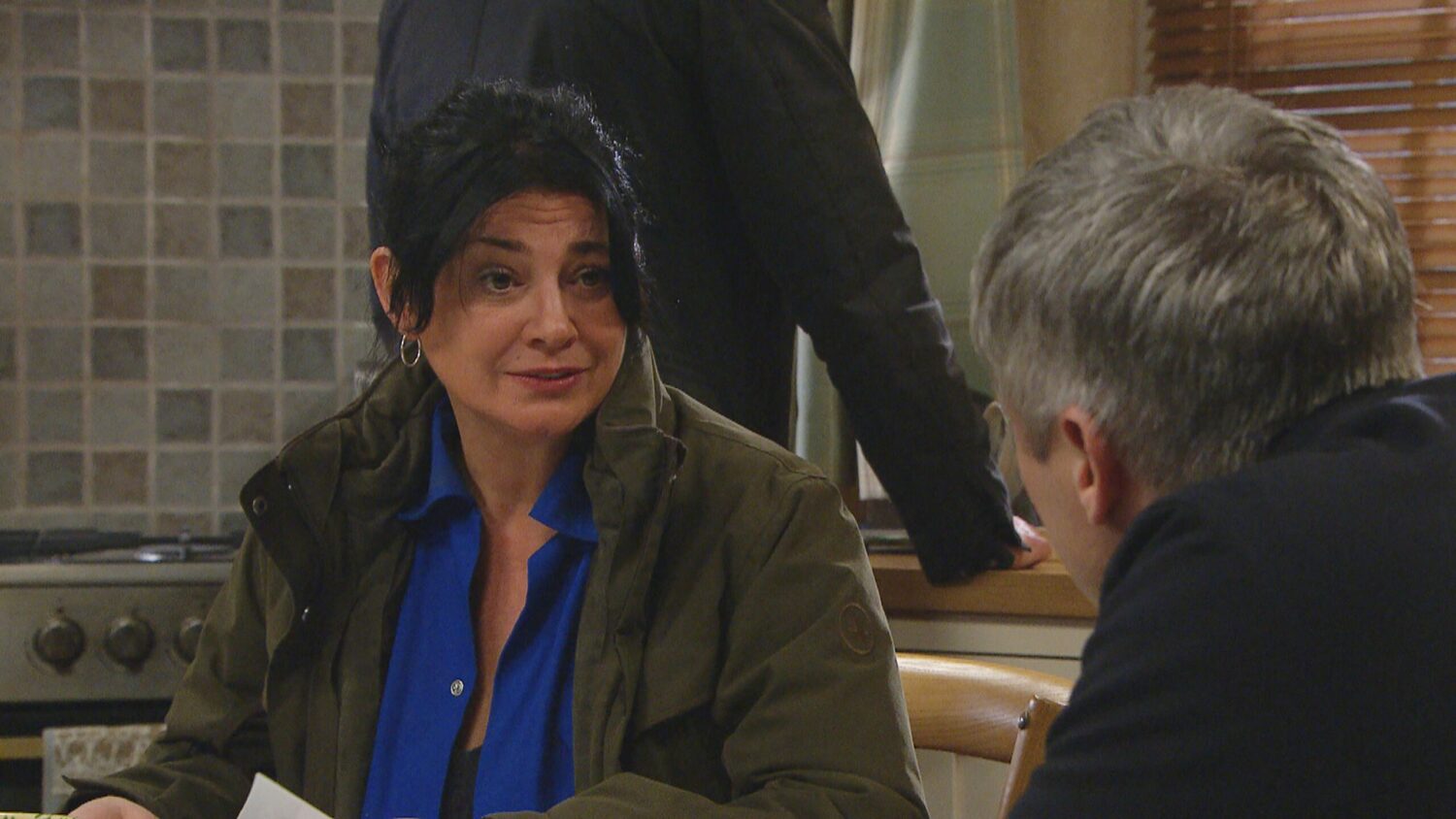 Moira Dingle looks worried as she talks to Caleb at Butlers' Farm in the kitchen