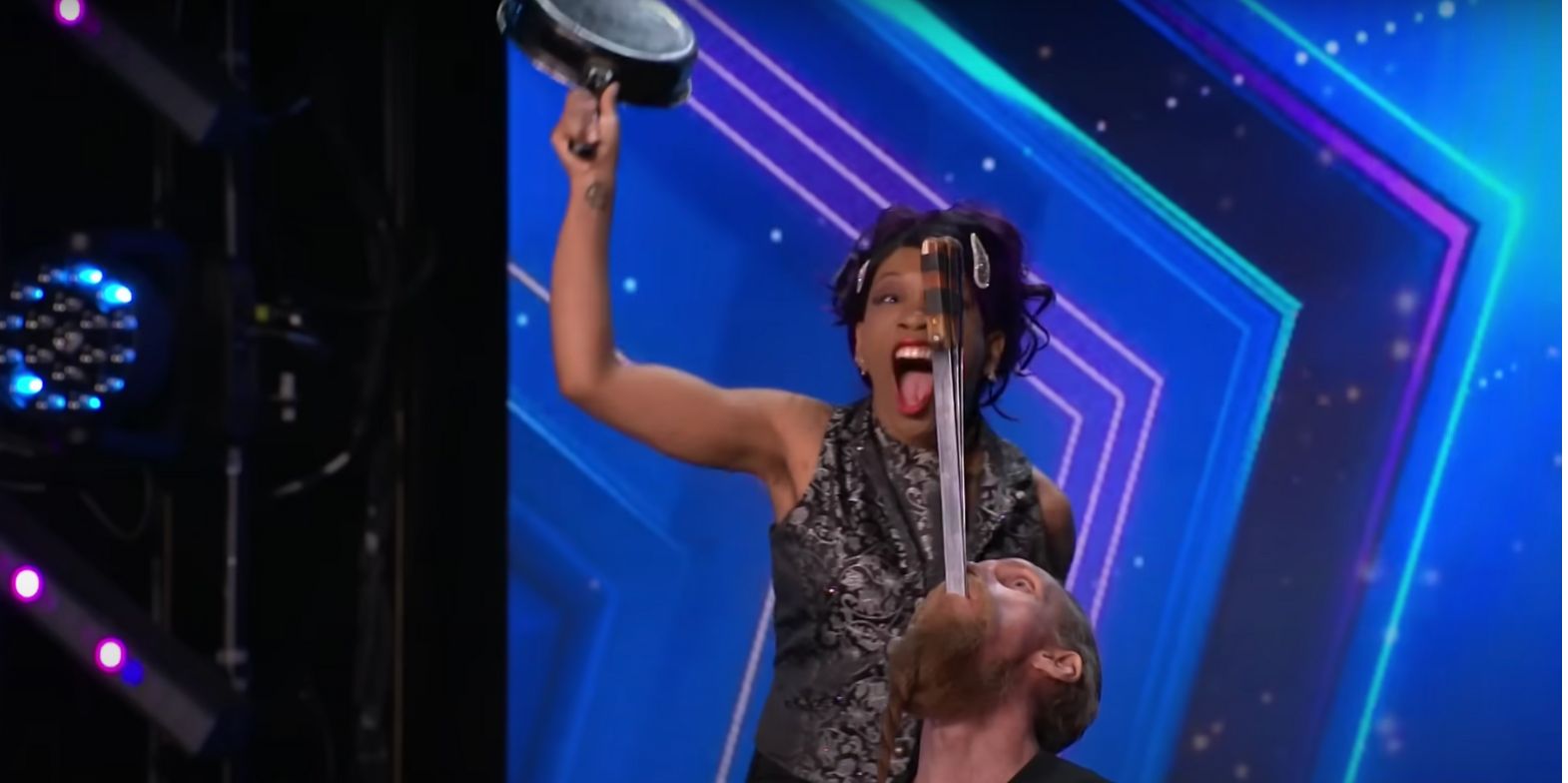 Sword swallower Andrew Stanton and assistant performing act