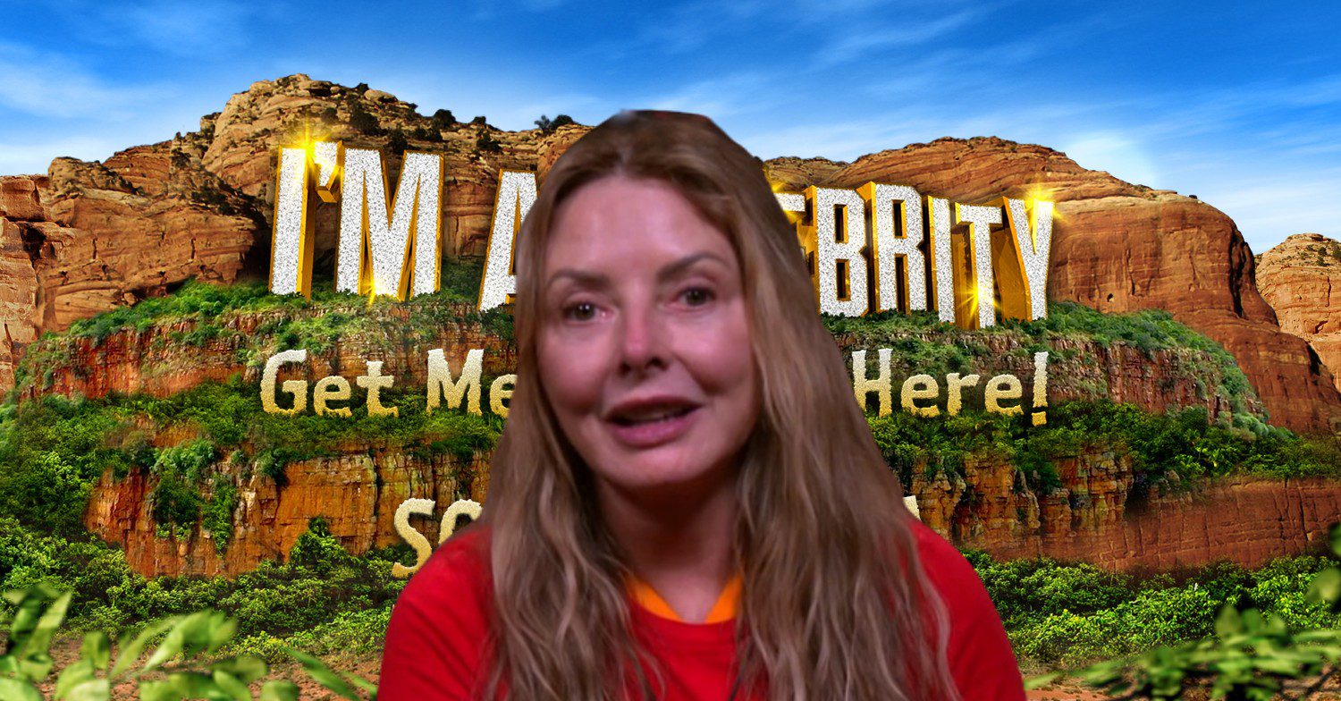 Carol Vorderman speaking in front on I'm A Celebrity South Africa logo