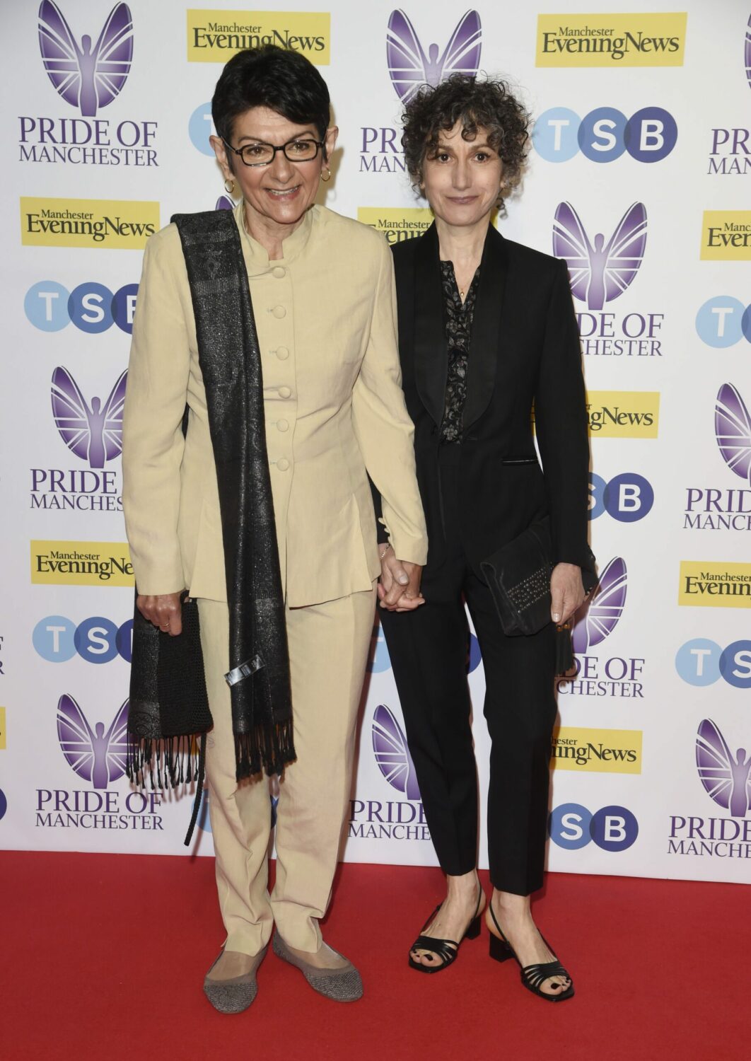 Shelley King and her partner Trilby James hold hands at the Price of Manchester Awards