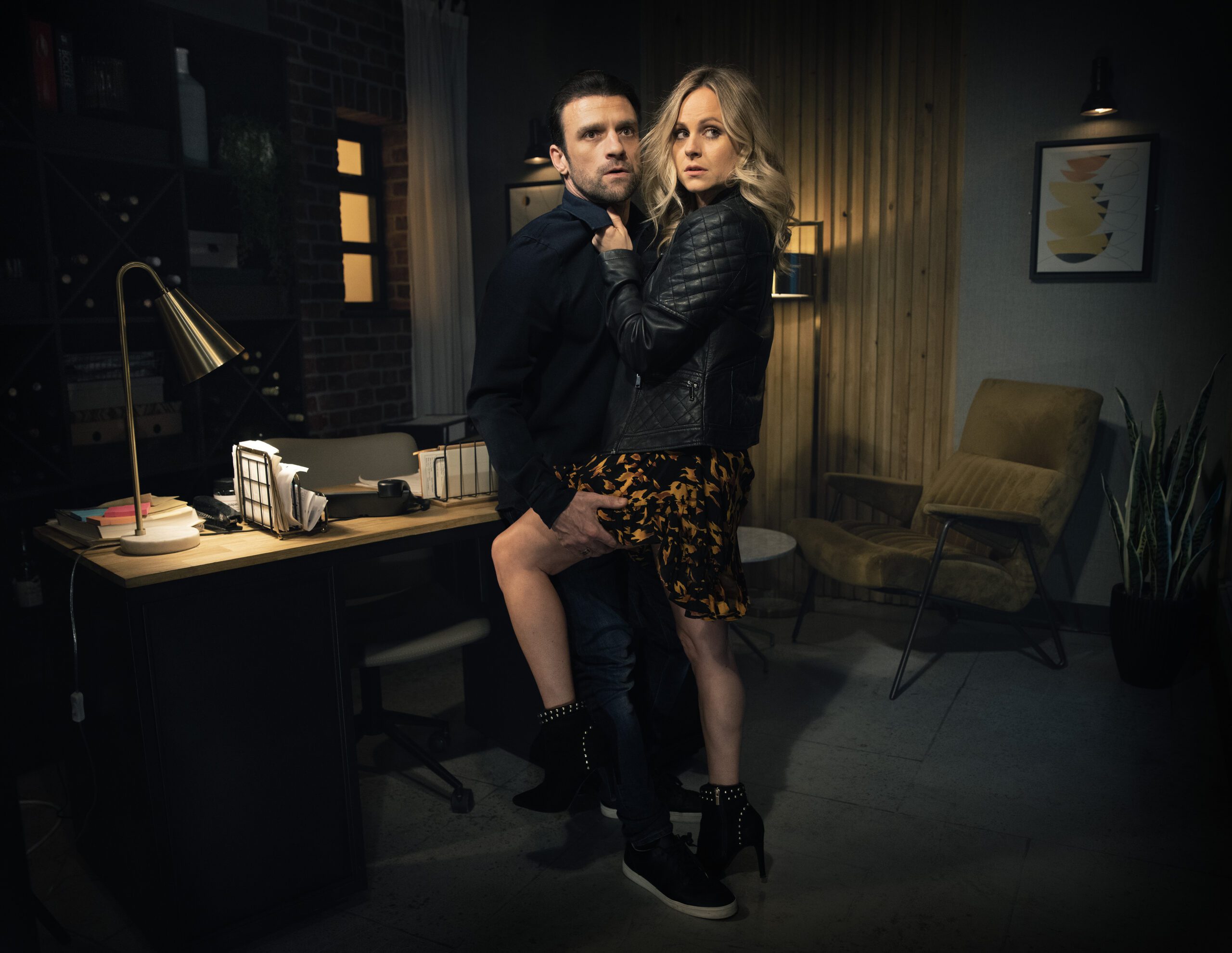 Coronation Street's Damon and Sarah are holding onto each other in the Bistro office