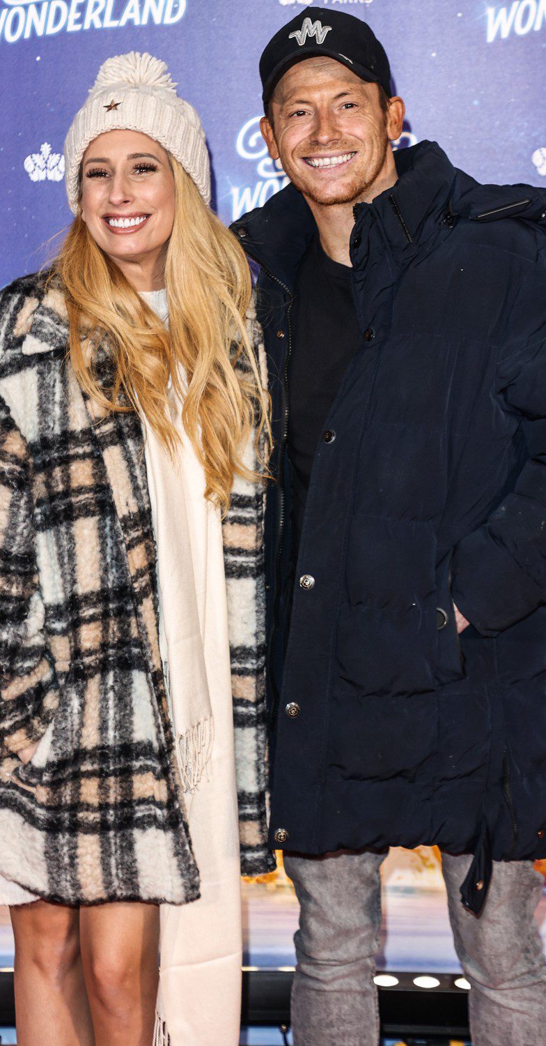 Joe Swash and Stacey Solomon smiling wearing hats