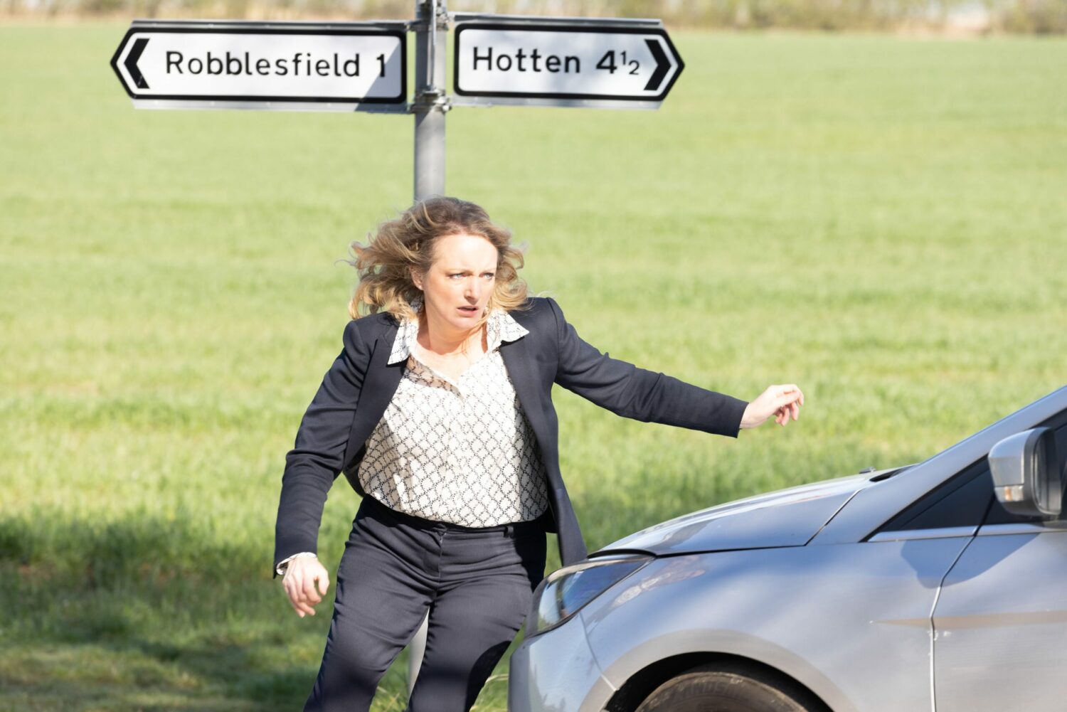 Terrified Nicola King races round to the passenger side of the car in Emmerdale