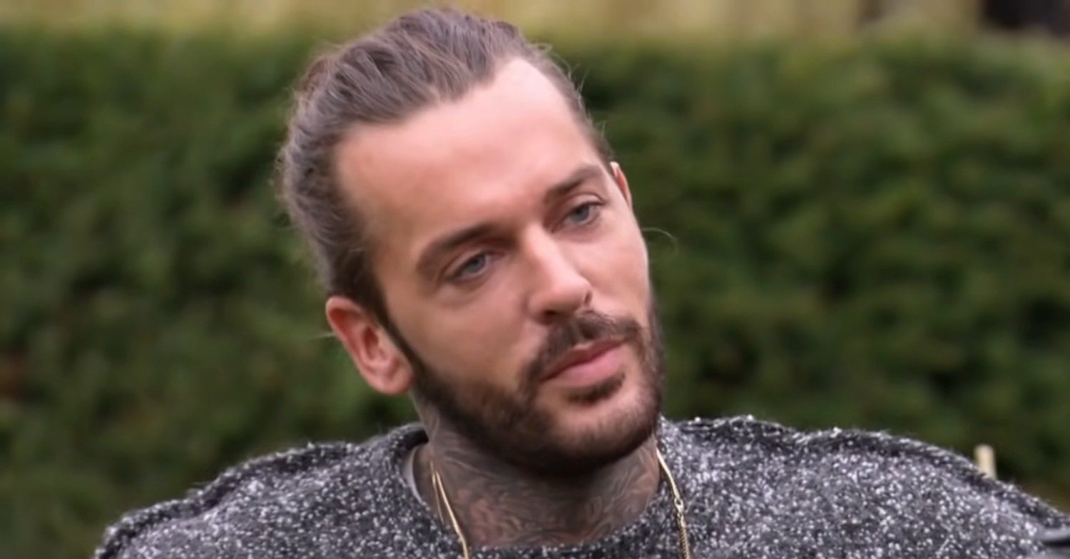 Pete Wicks chatting with a bush behind his head