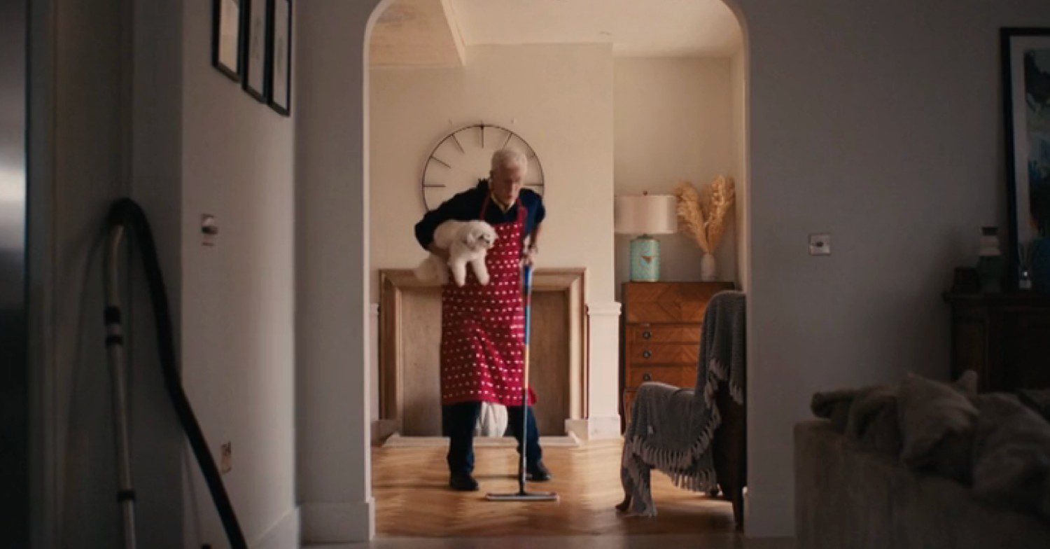 Paul O'Grady mopping while holding his dog on Eurovision 