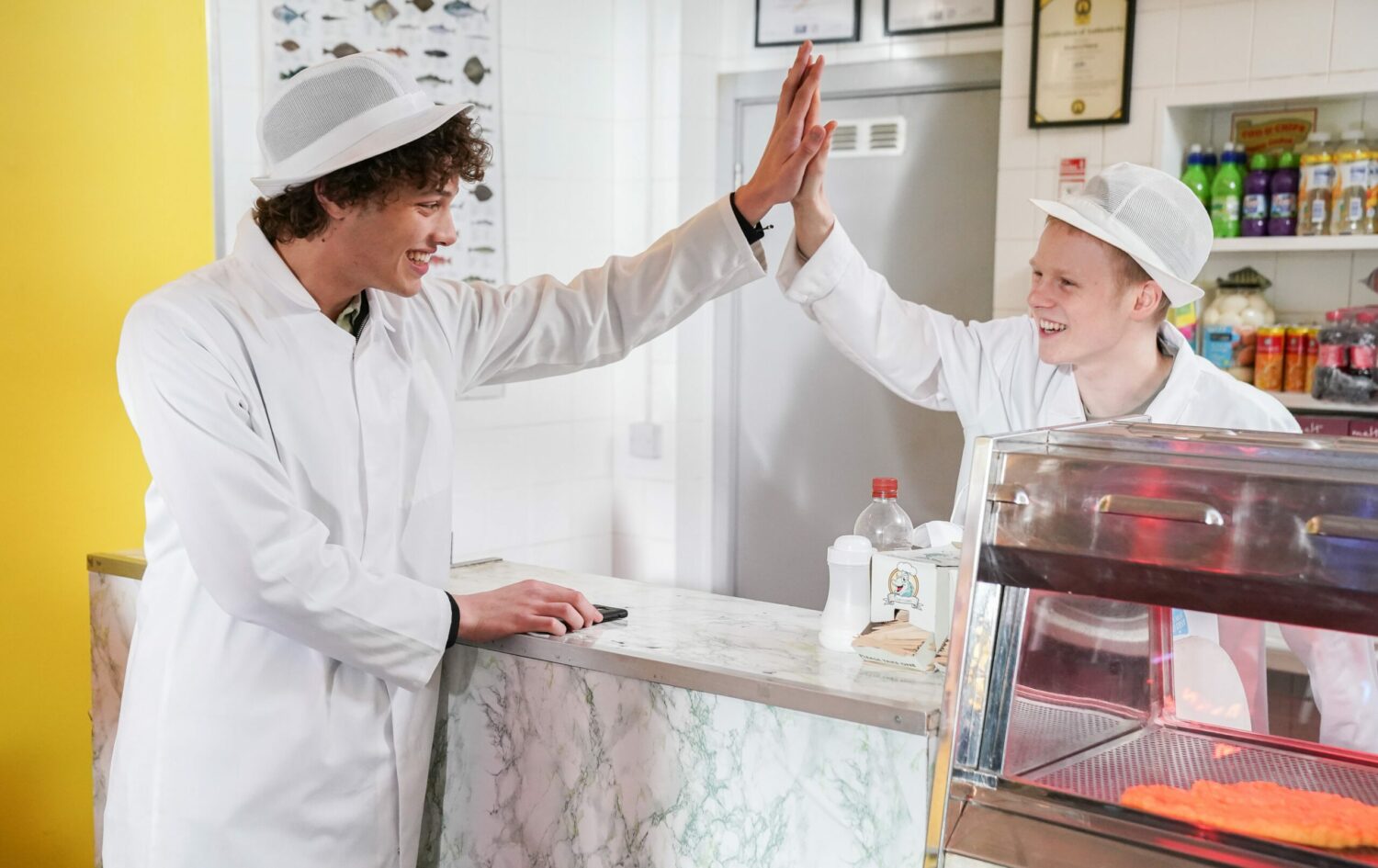 Freddie high fives Bobby in the chippy