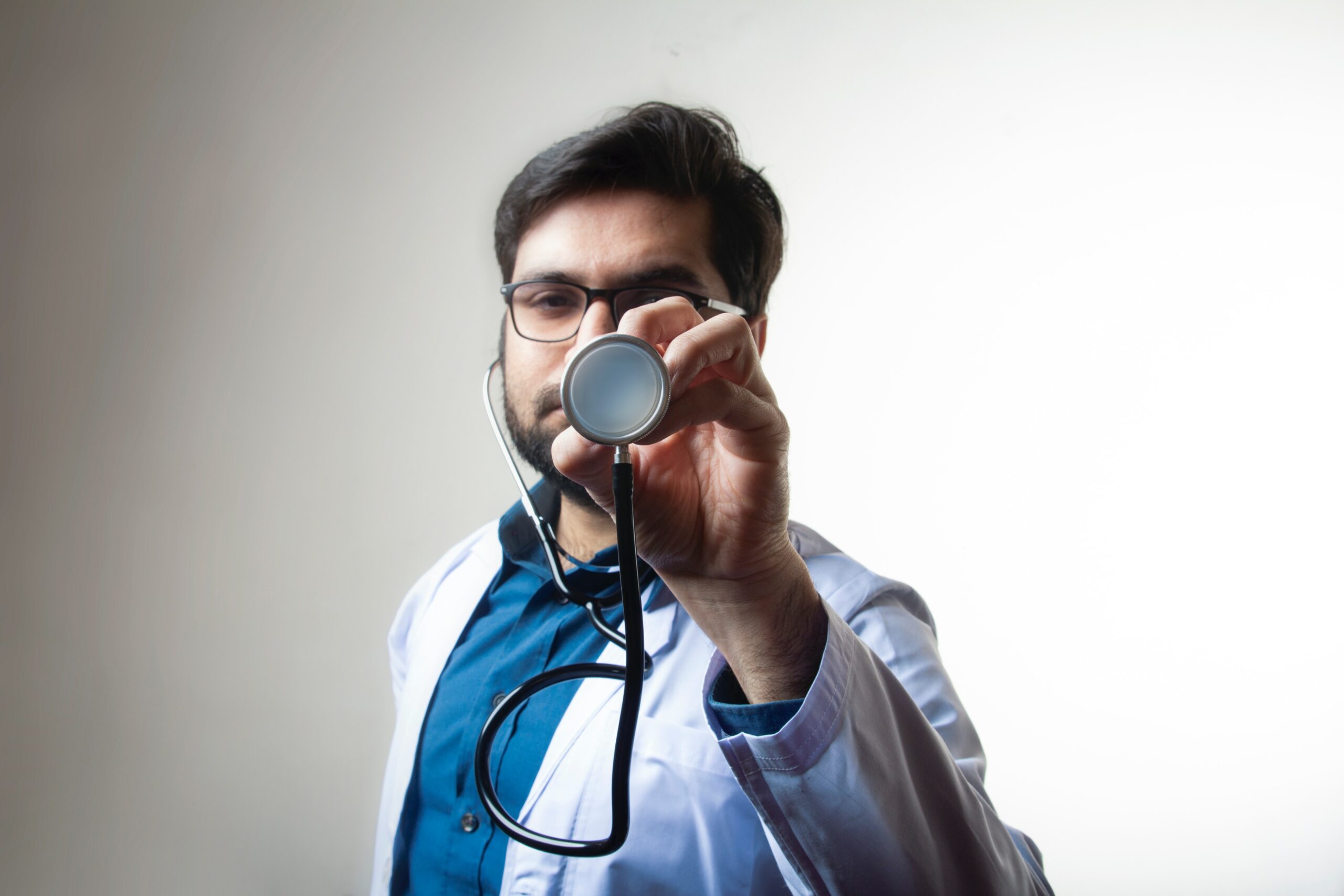 A GP holding a stethoscope 