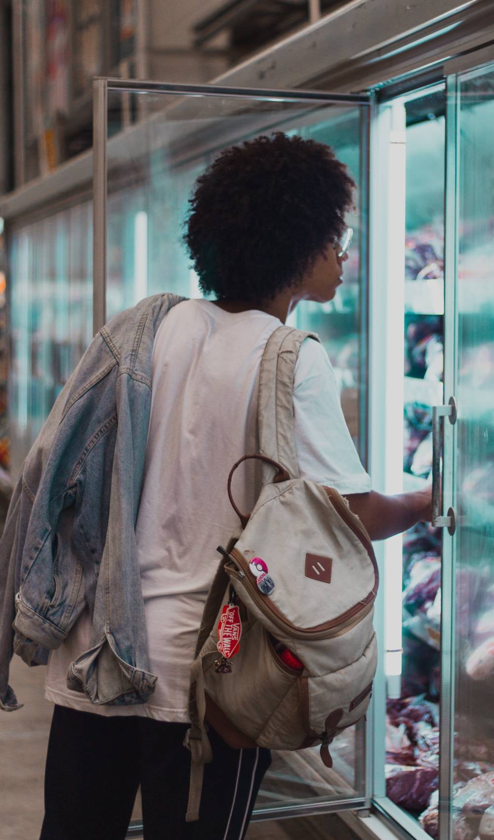 Woman looks into fridge