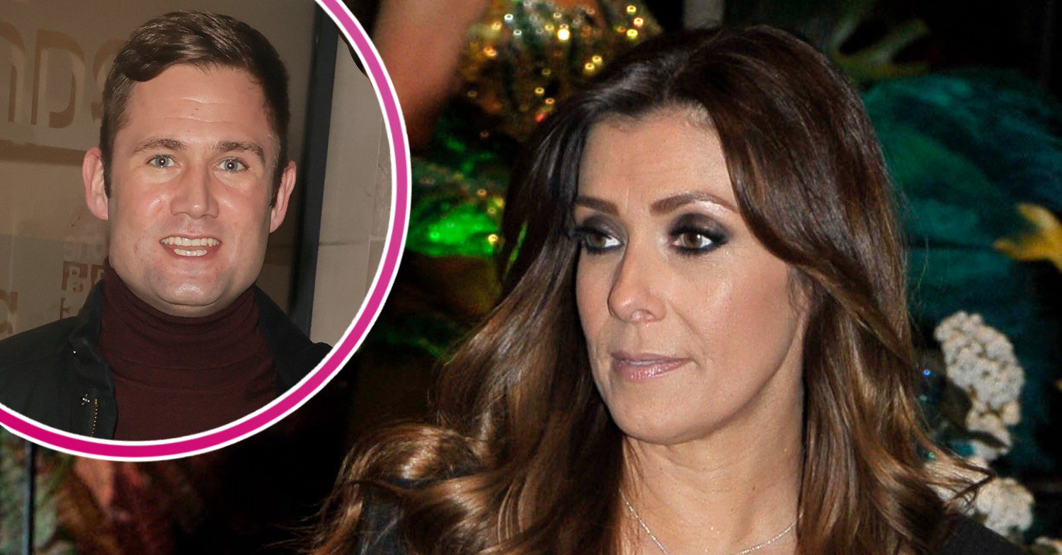 Kym Marsh looking serious with her husband smiling