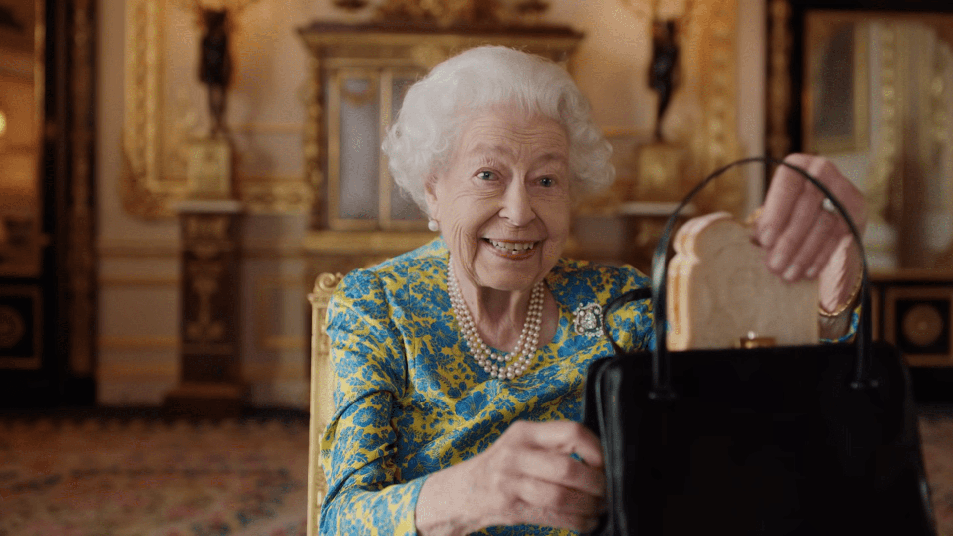 The Queen smiles with marmalade sandwich