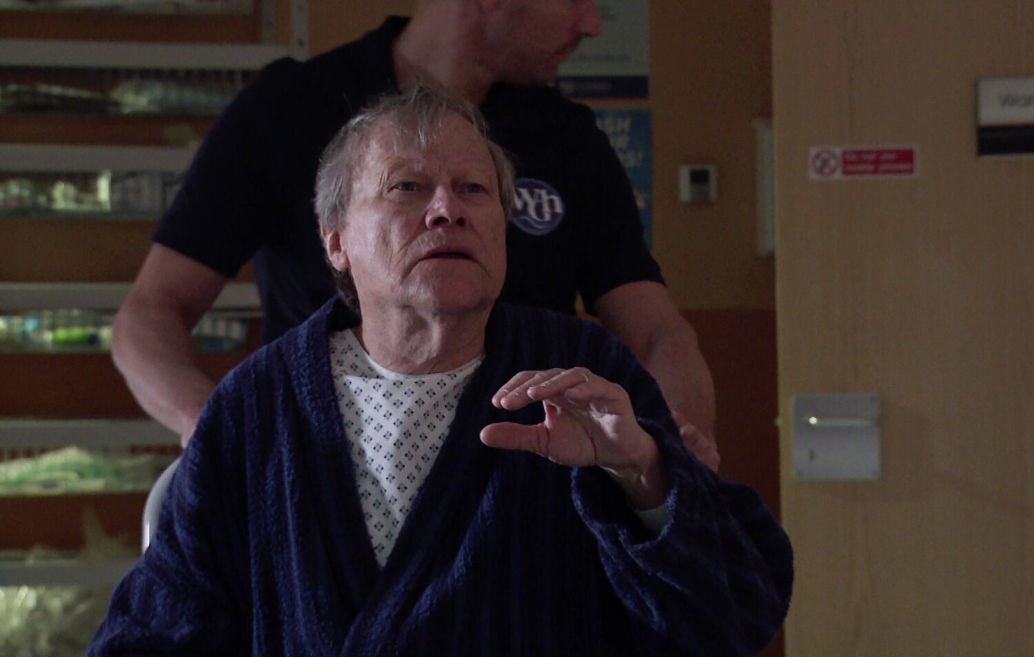 Roy looking scared as he's wheeled away by nurses on Corrie