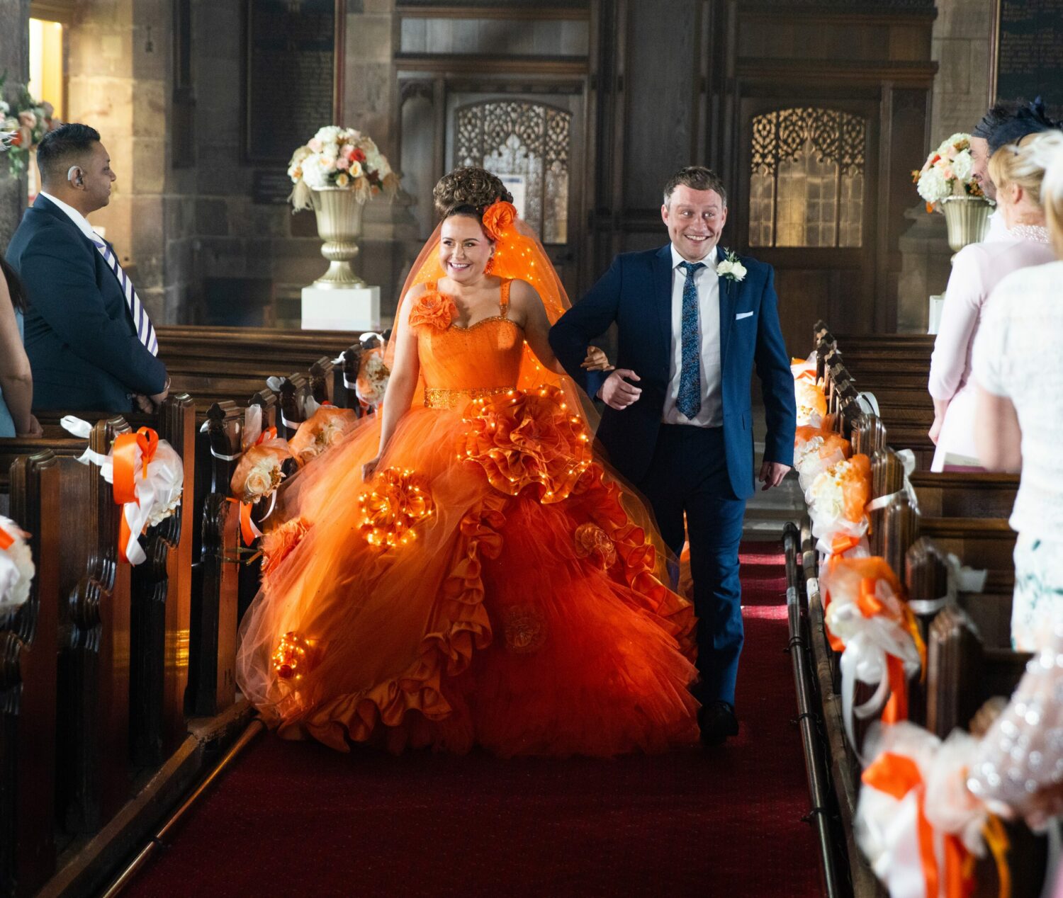 Gemma walks down with aisle with Paul in Corrie - she's in a bright orange wedding dress