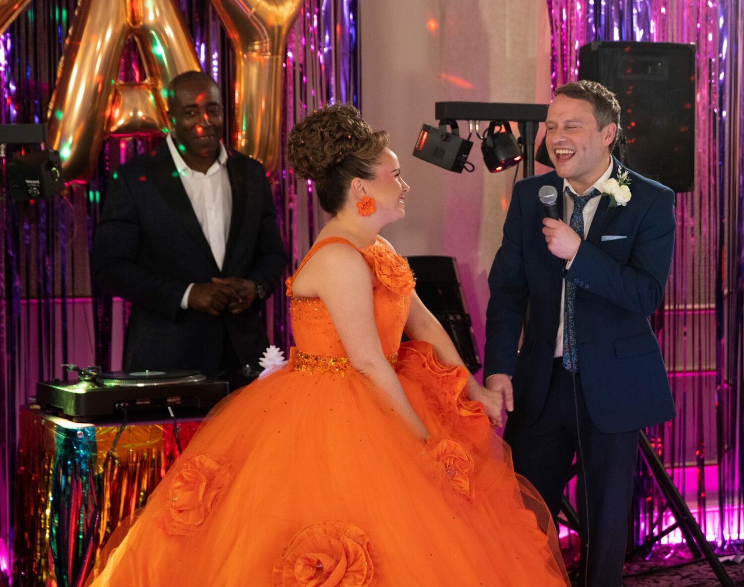 Gemma and Paul smile as they perform a duet in Corrie