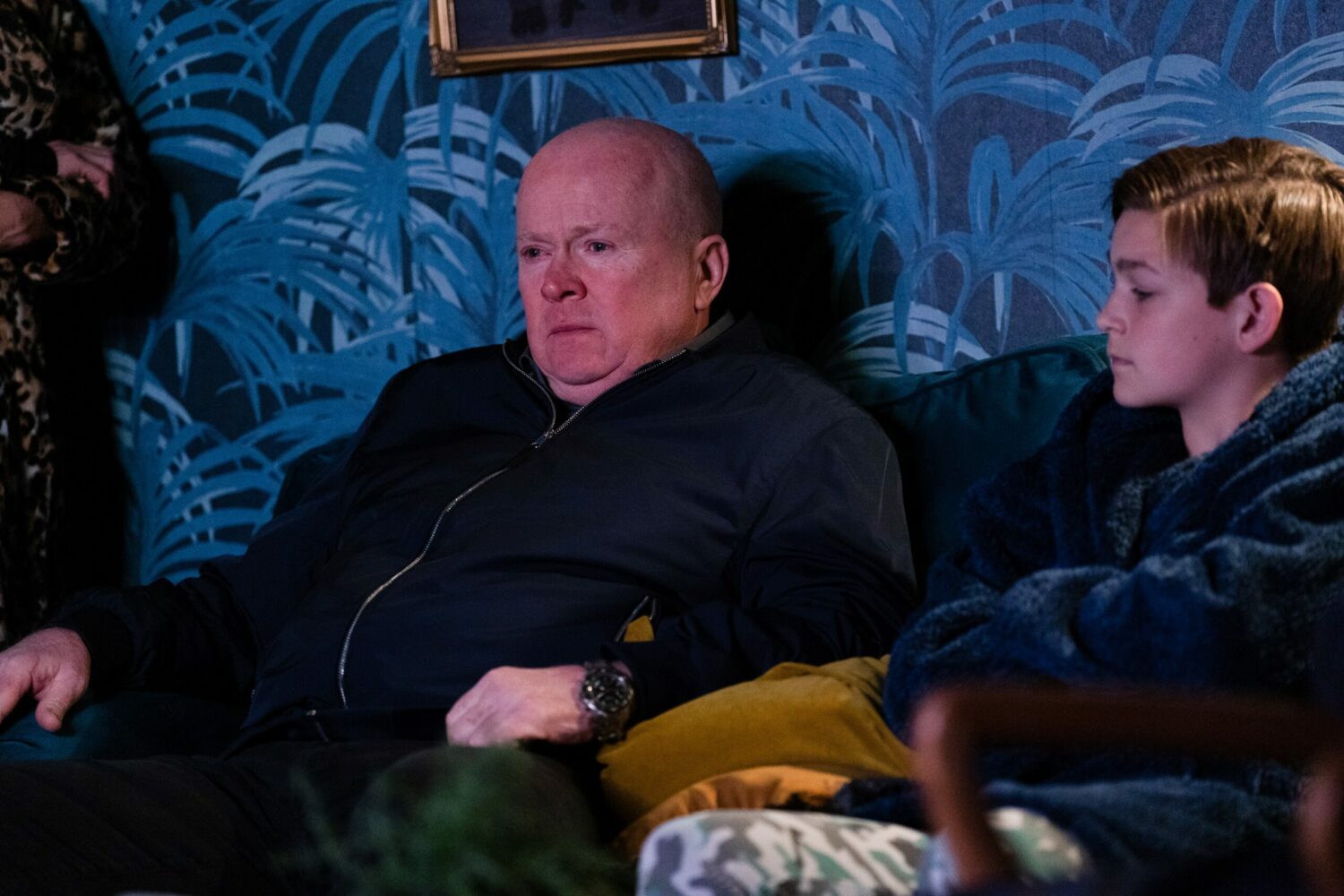 Devastated Phil Mitchell is tearful as he sits on the sofa with Tommy Moon
