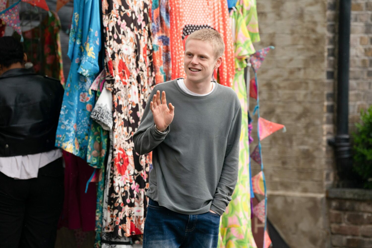 Bobby Beale waves nervously in the market while smiling