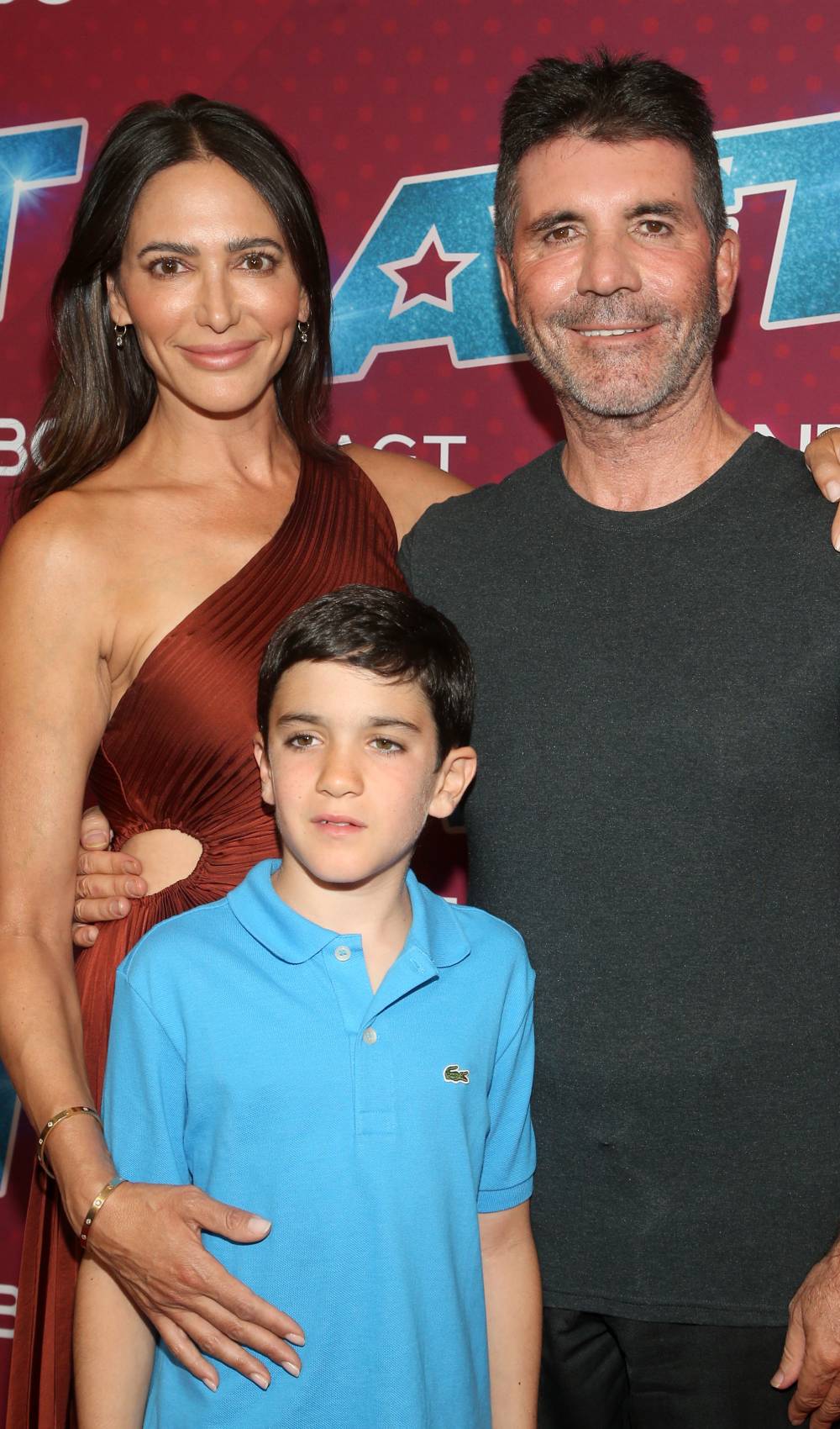 Simon Cowell poses with partner Lauren Silverman and son Eric