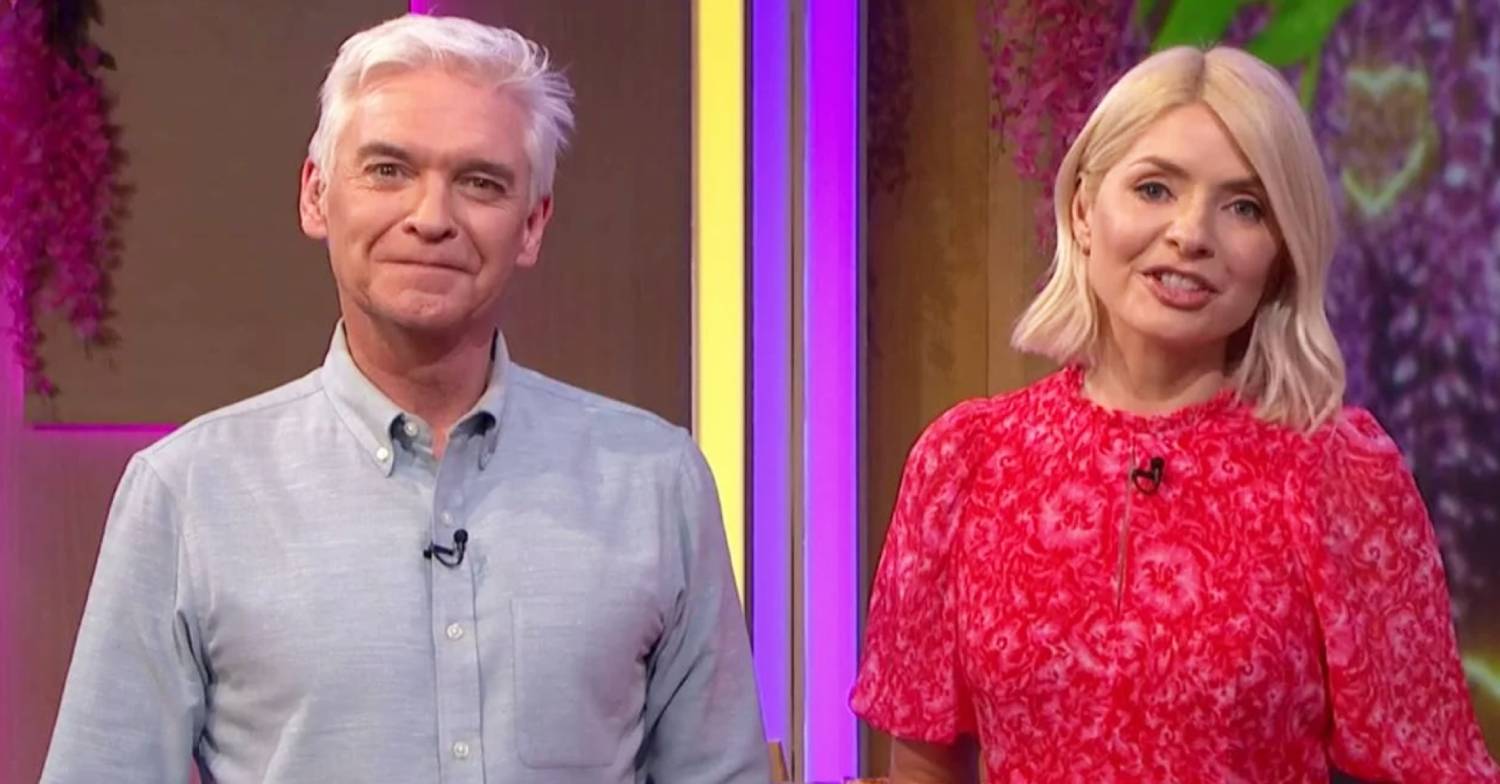 Phillip Schofield smiles as Holly Willoughby signs off during his last scenes for This Morning