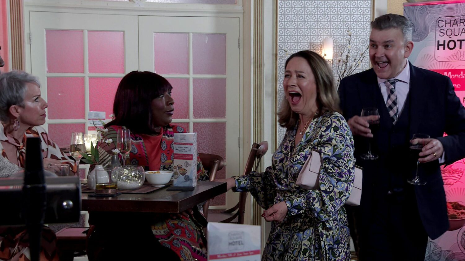 Coronation Street's Debbie and Aggie are looking at an excited Yvette and Patrick in the hotel