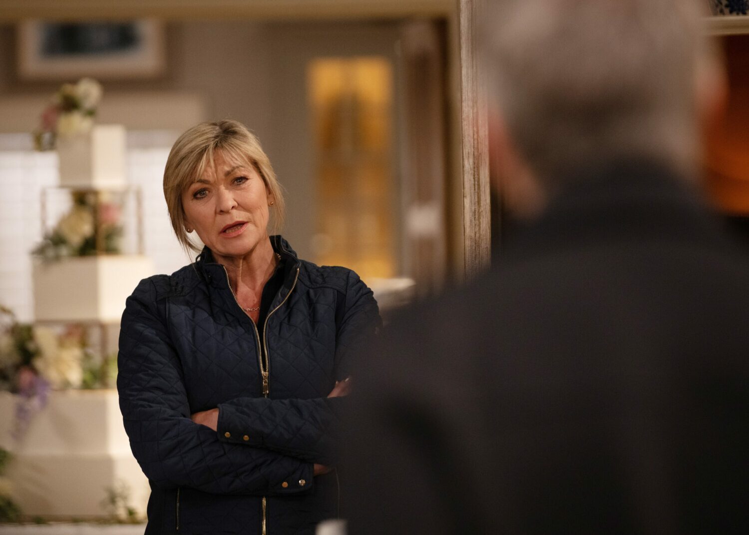 Emmerdale's Kim has her arms folded as she's staring at Caleb in Home Farm