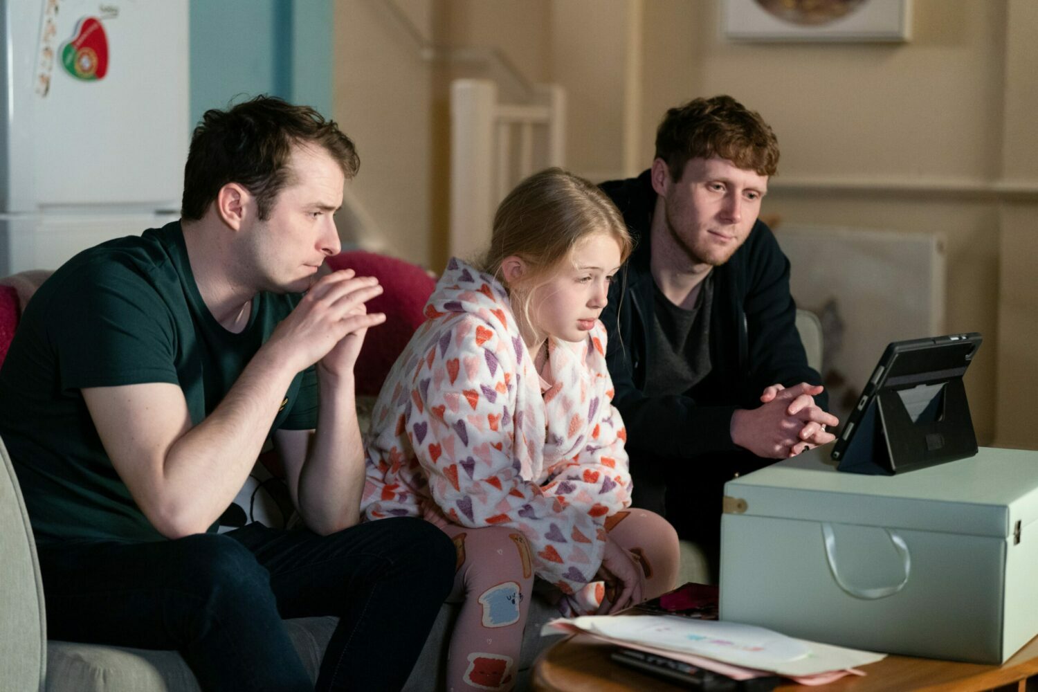 EastEnders' Ben, Lexi and Jay are sitting together, upset, on the sofa