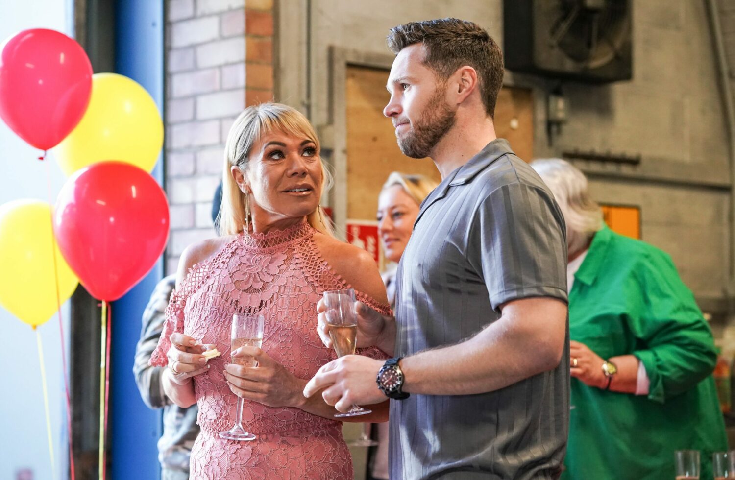 EastEnders' Sharon and Keanu are holding a glass of alcohol with balloons in the background