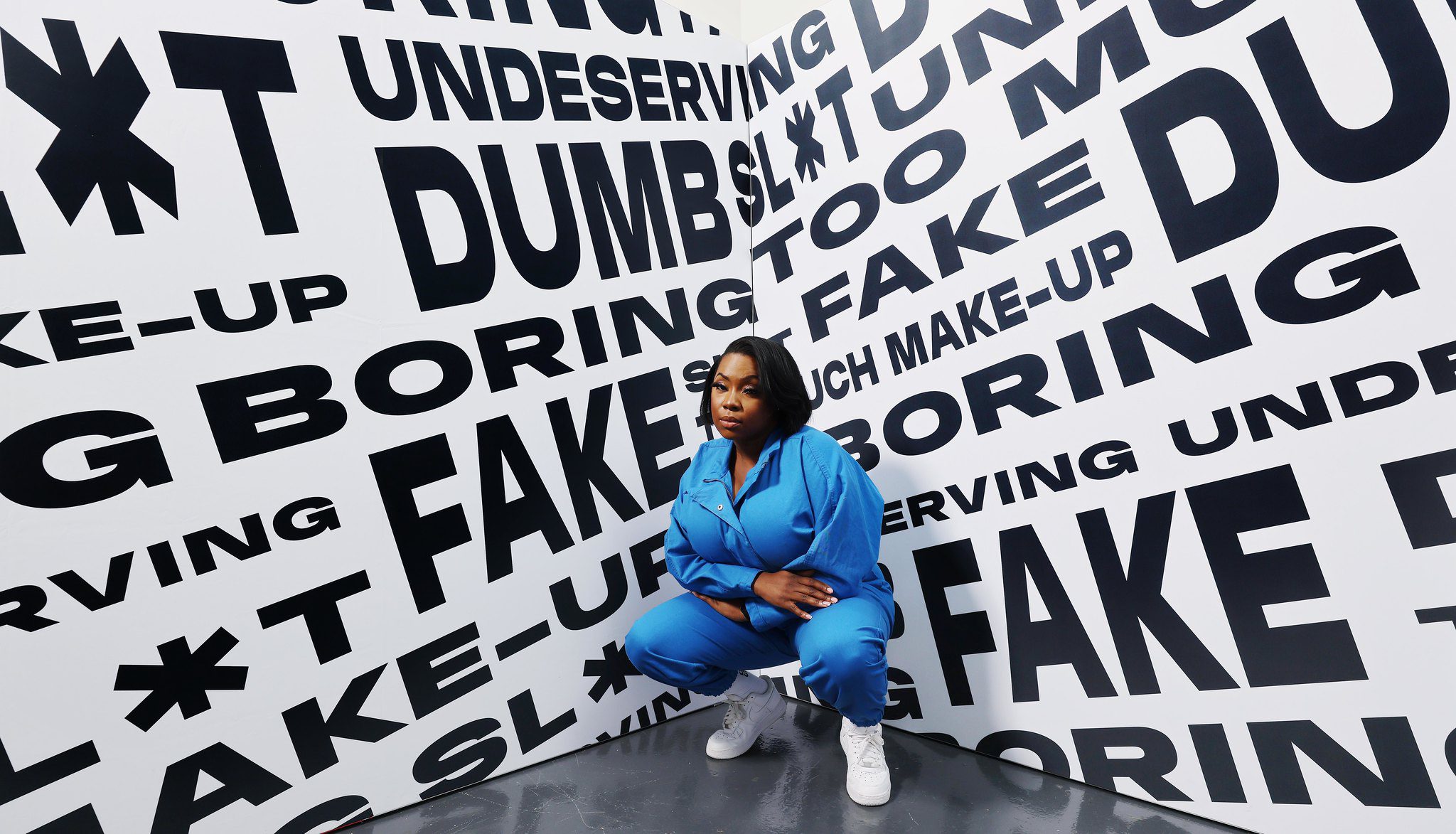 Woman posing in front of poster