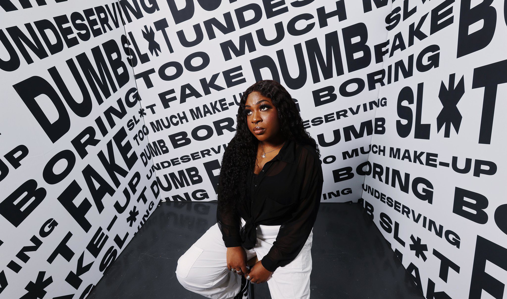 Woman posing in front of poster