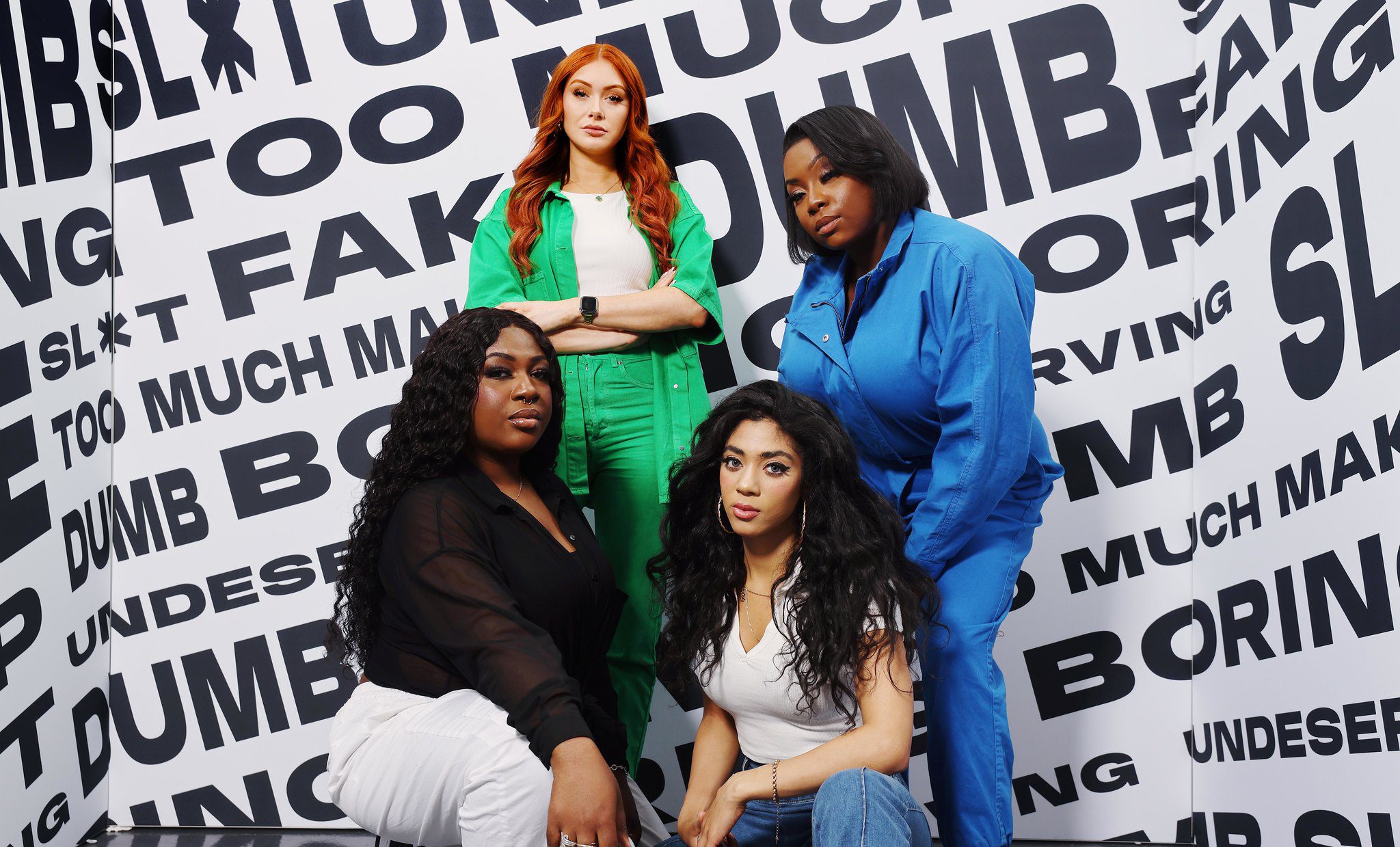 Women posing in front of poster