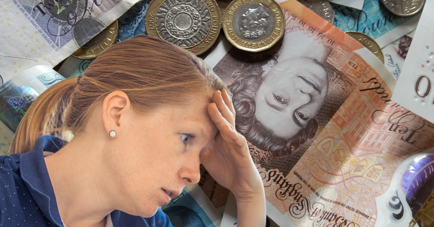 A stressed woman in front of money