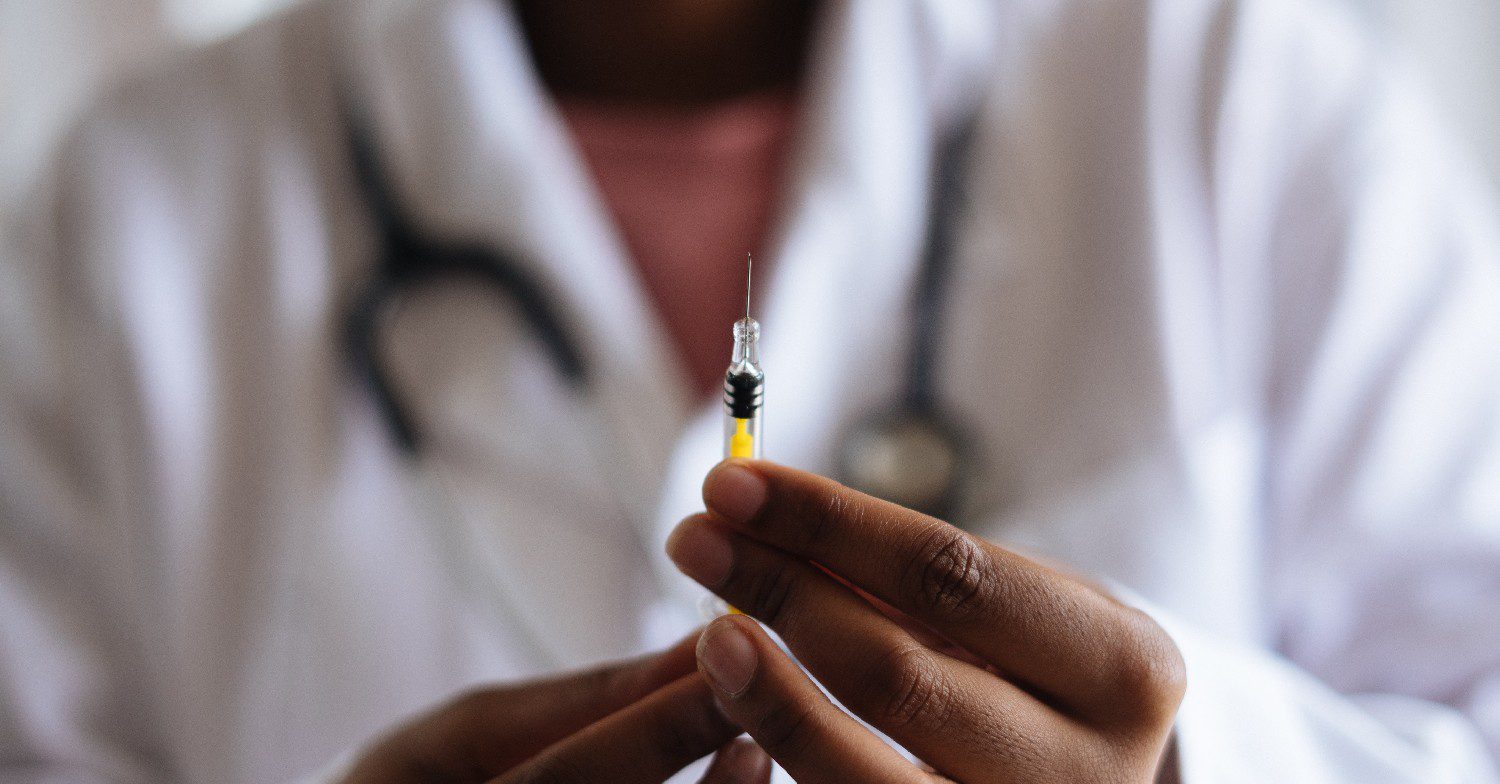 Doctor holding an injection 