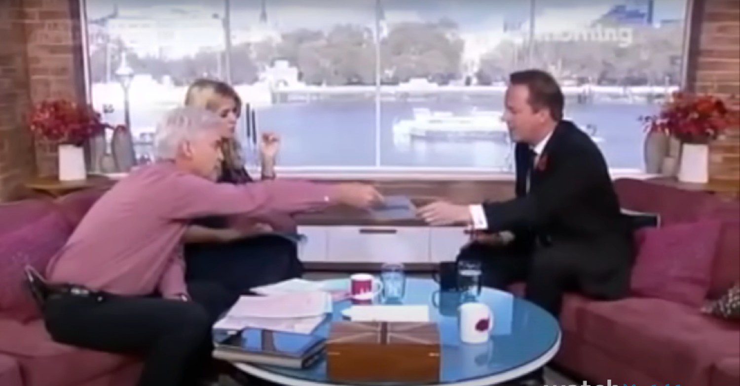 Phillip Schofield handing David Cameron a list on This Morning 