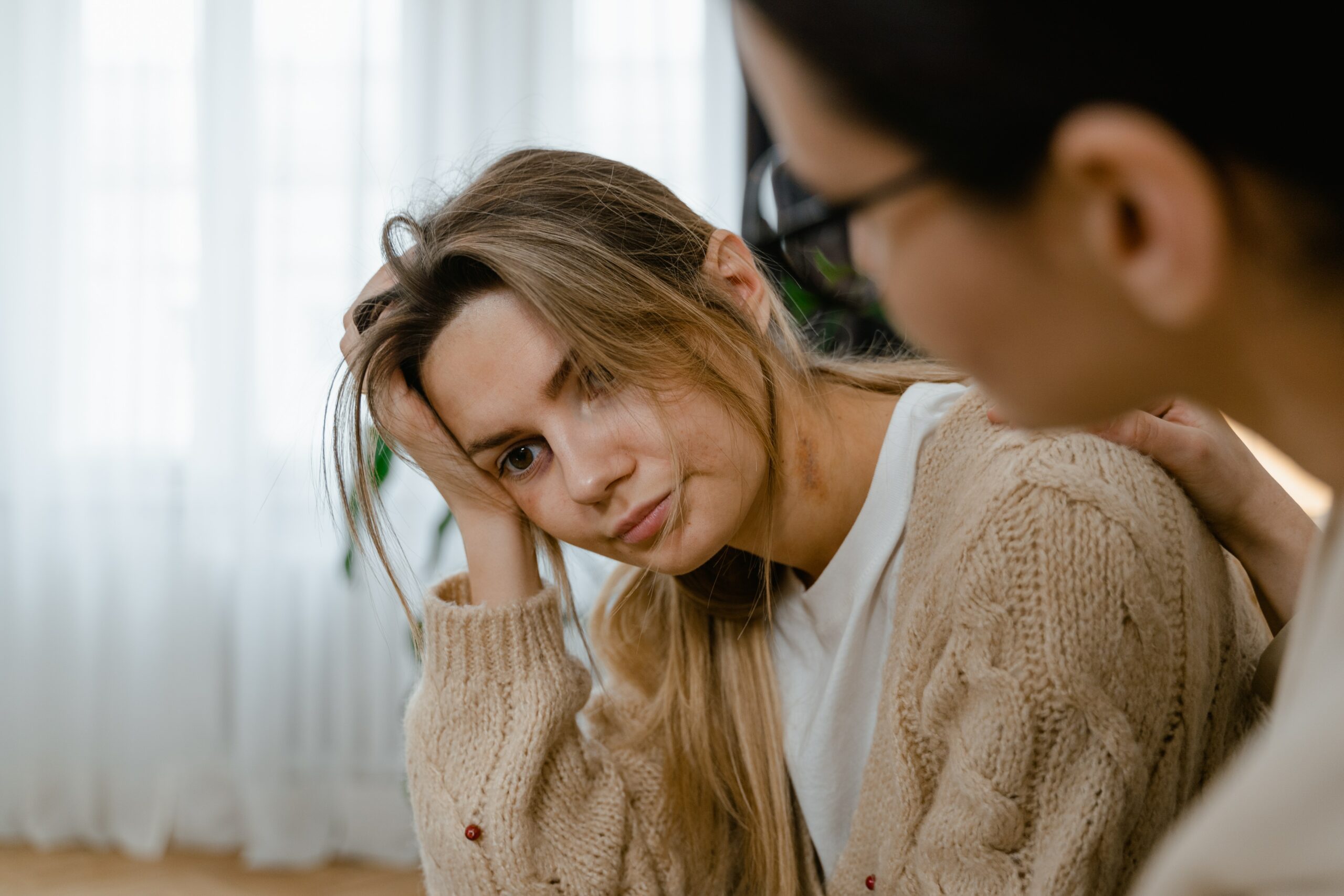 Stressed woman sits with friend