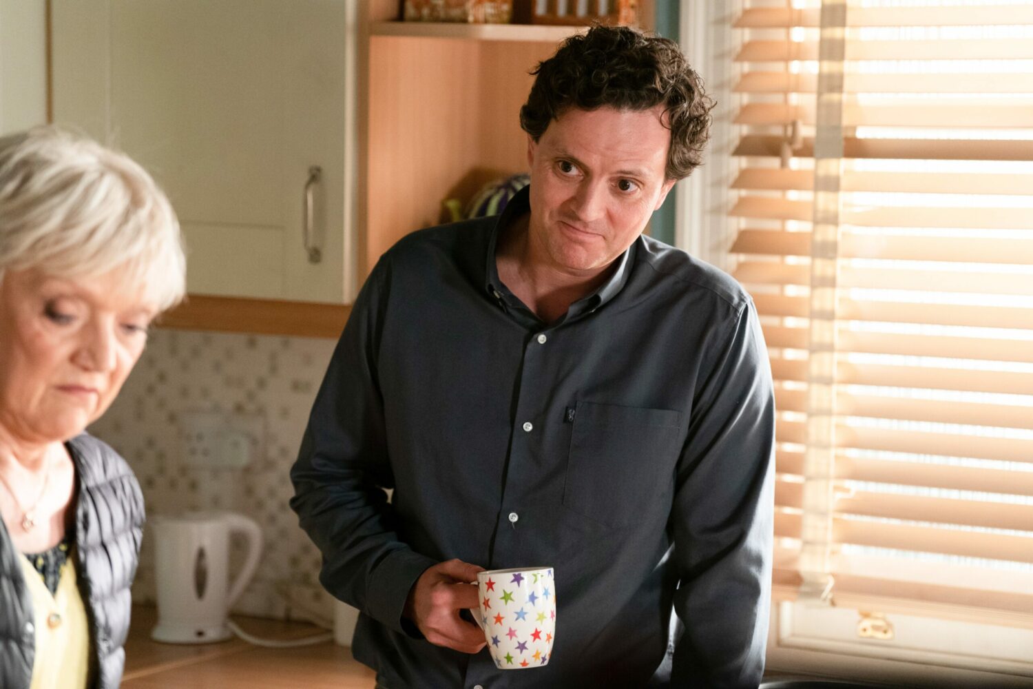 Theo looking creepy in Stacey's kitchen with Jean on EastEnders