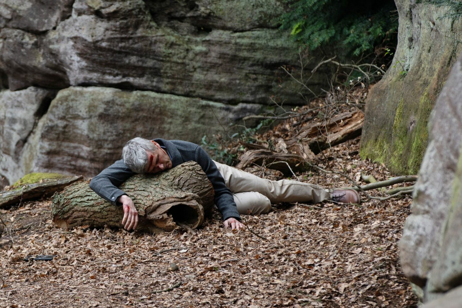 Caleb lying unconscious on the rocks in Emmerdale