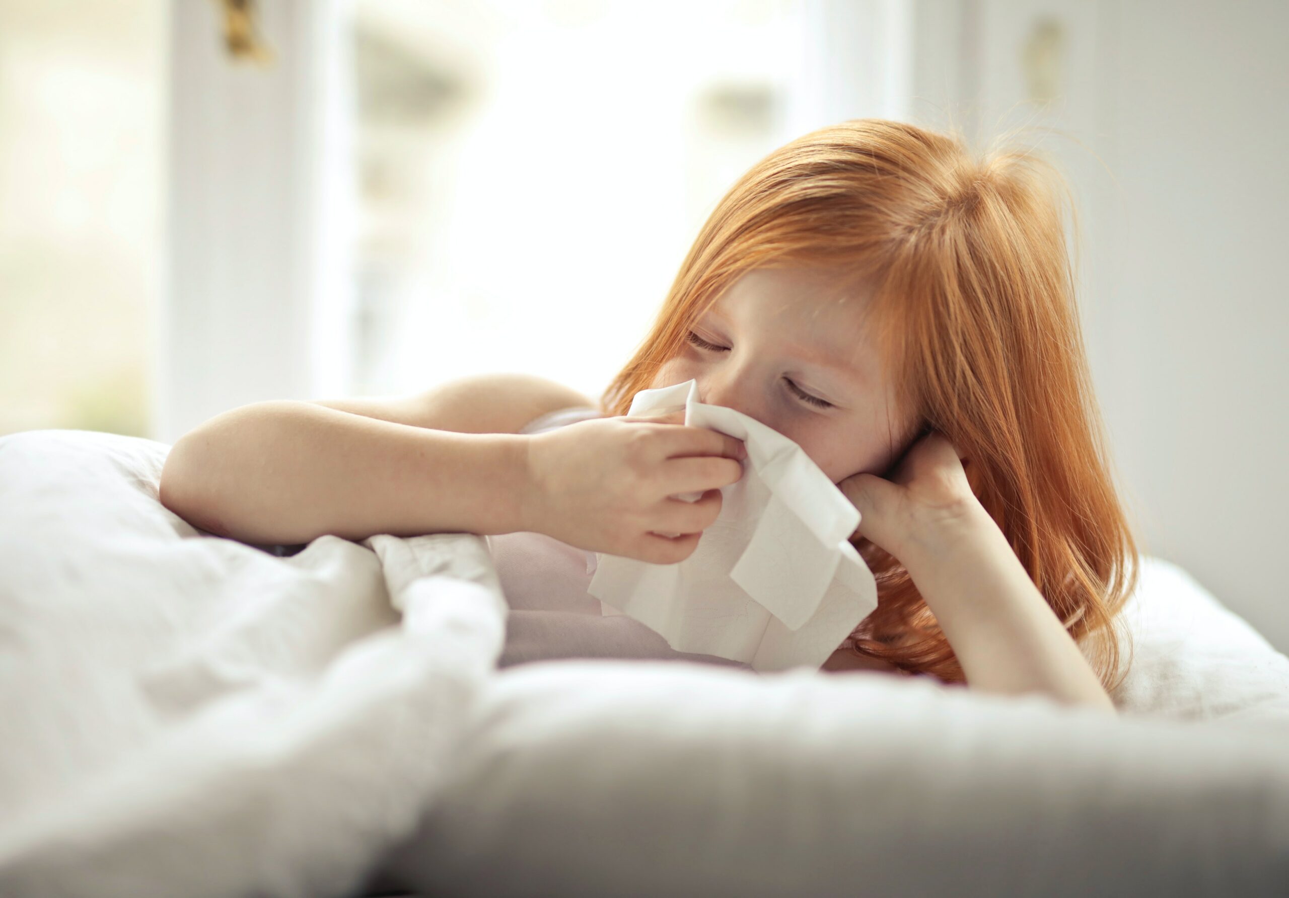 Sick child uses a tissue