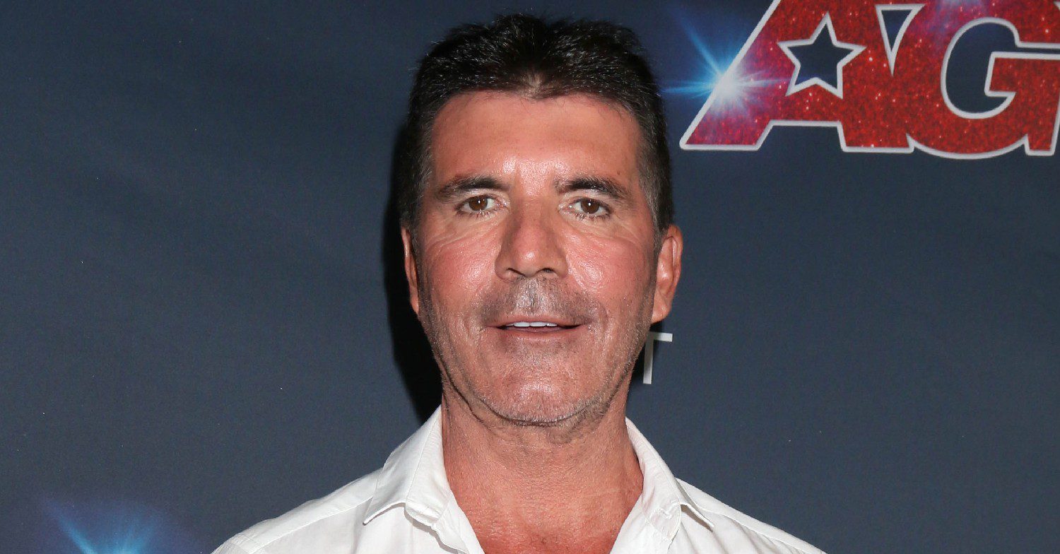 Simon Cowell posing on a red carpet 