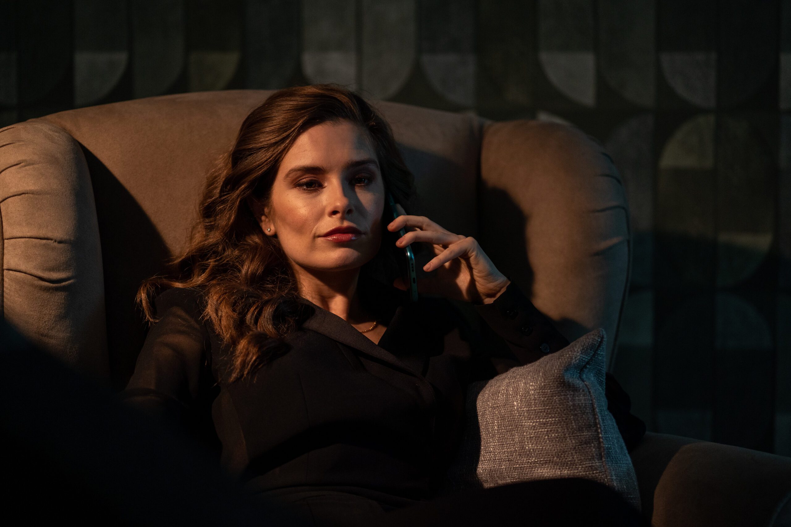 Emily speaks on the phone in For Her Sins