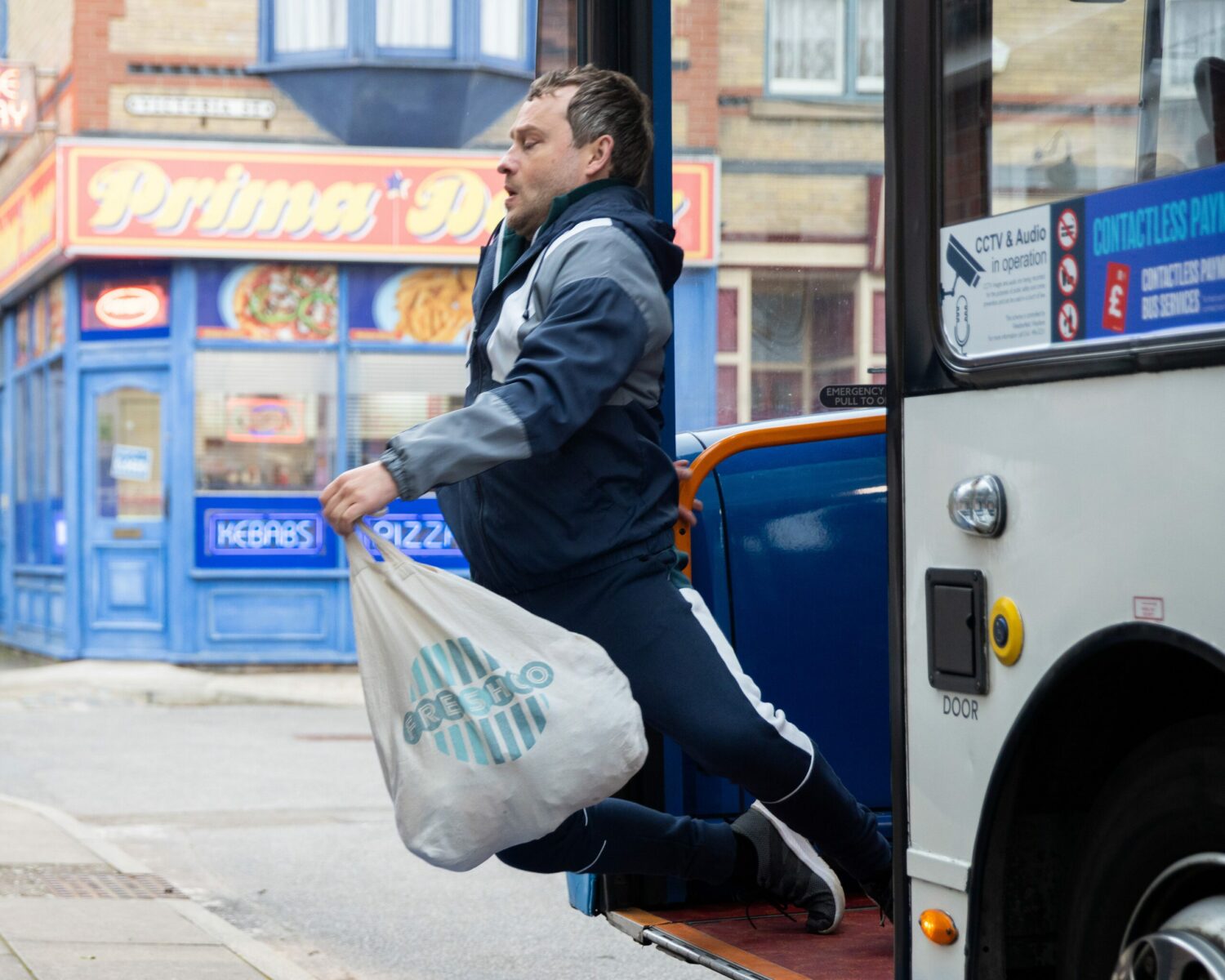 Paul in Corrie falls off the bus carrying his shopping