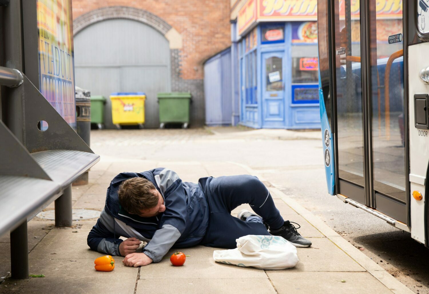 Coronation Street's Paul is on the floor with his shopping outside of the bus