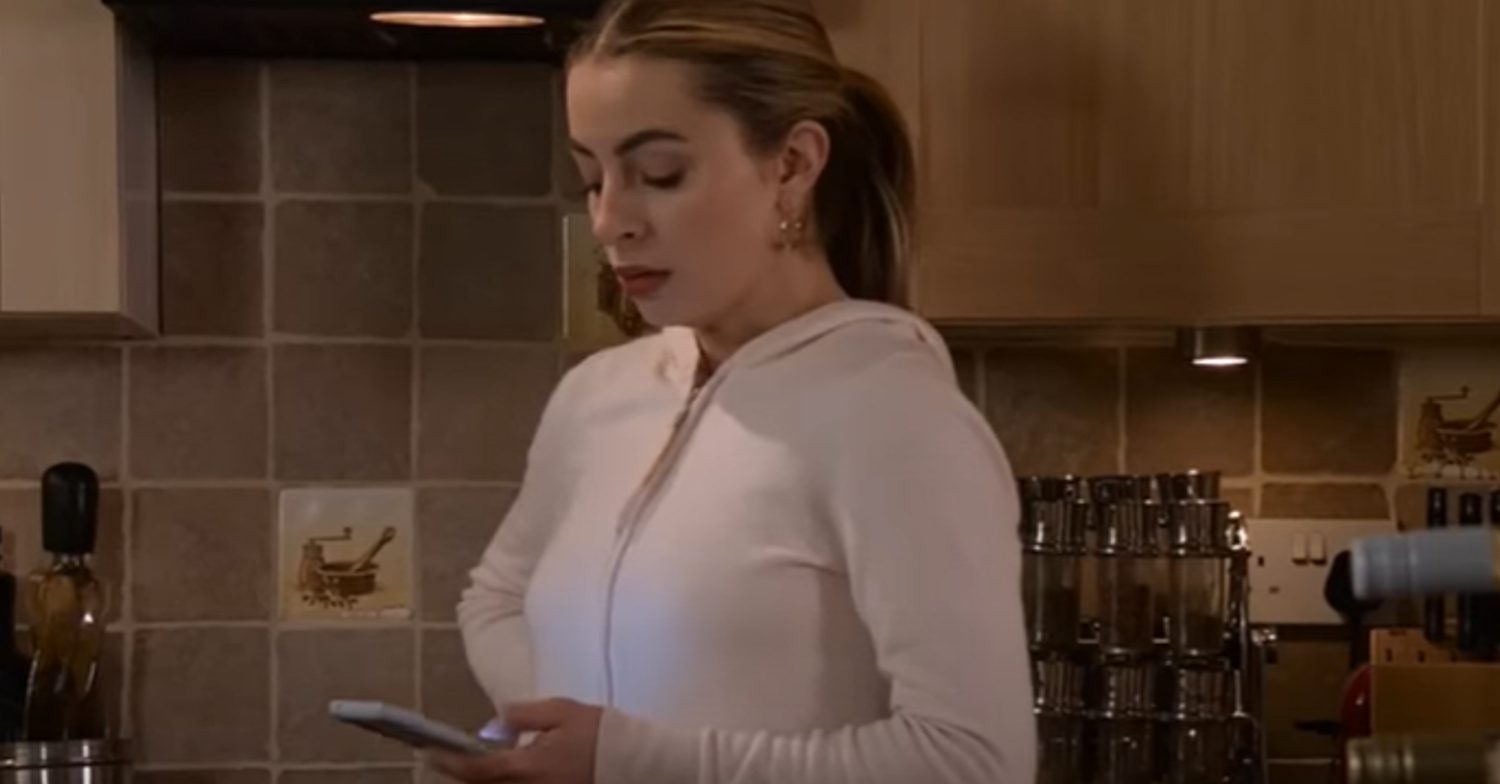 Coronation Street's Daisy is looking at her mobile phone